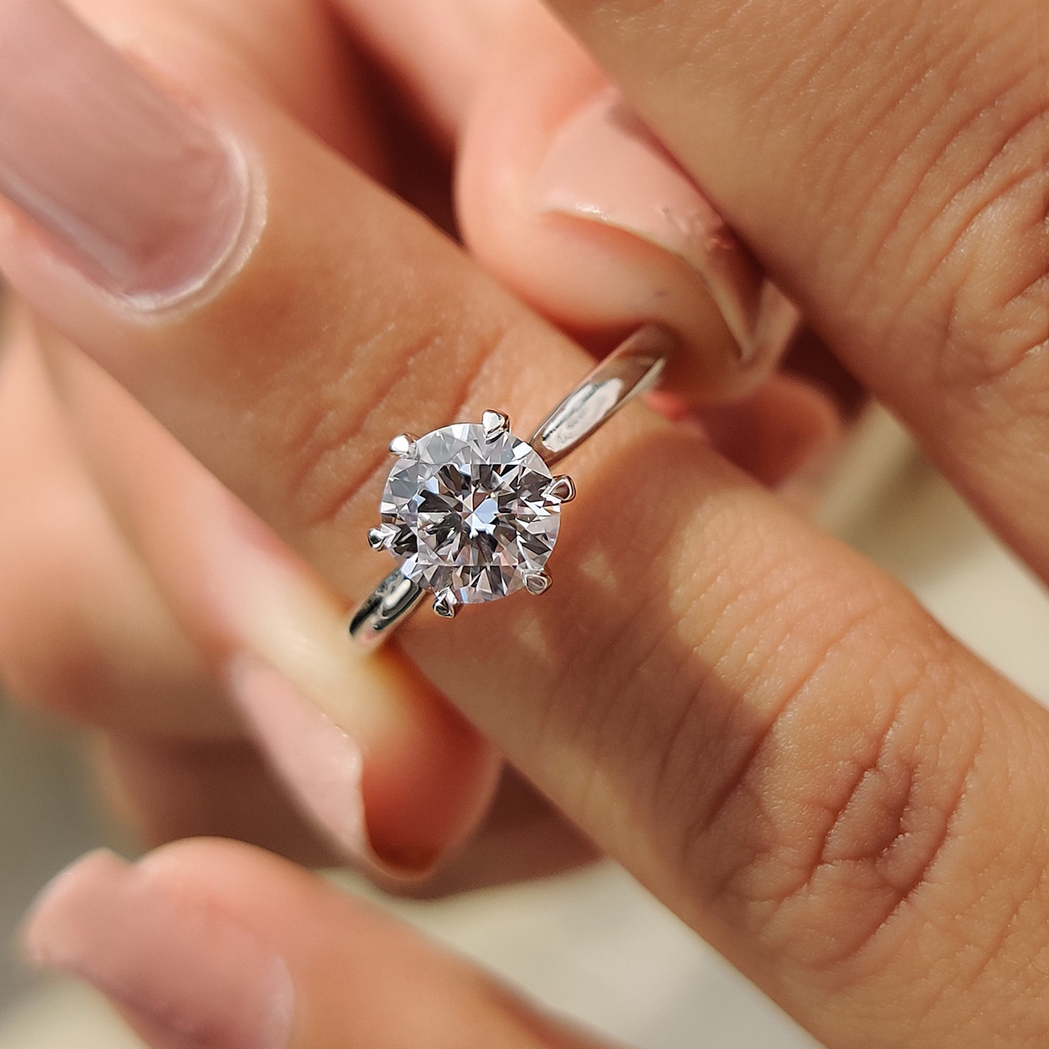 Diamond ring solitaire featuring a minimalist design with a single stone focus.
