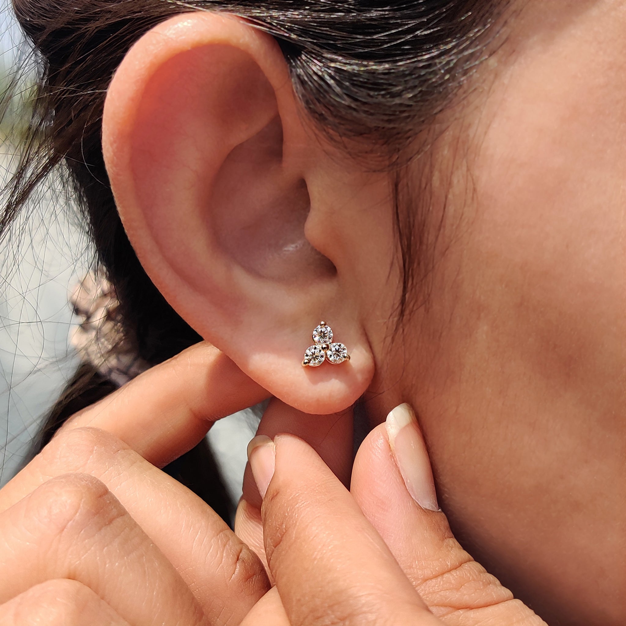 Yellow gold earrings used in round cut Moissanite three stone earrings with custom design.
