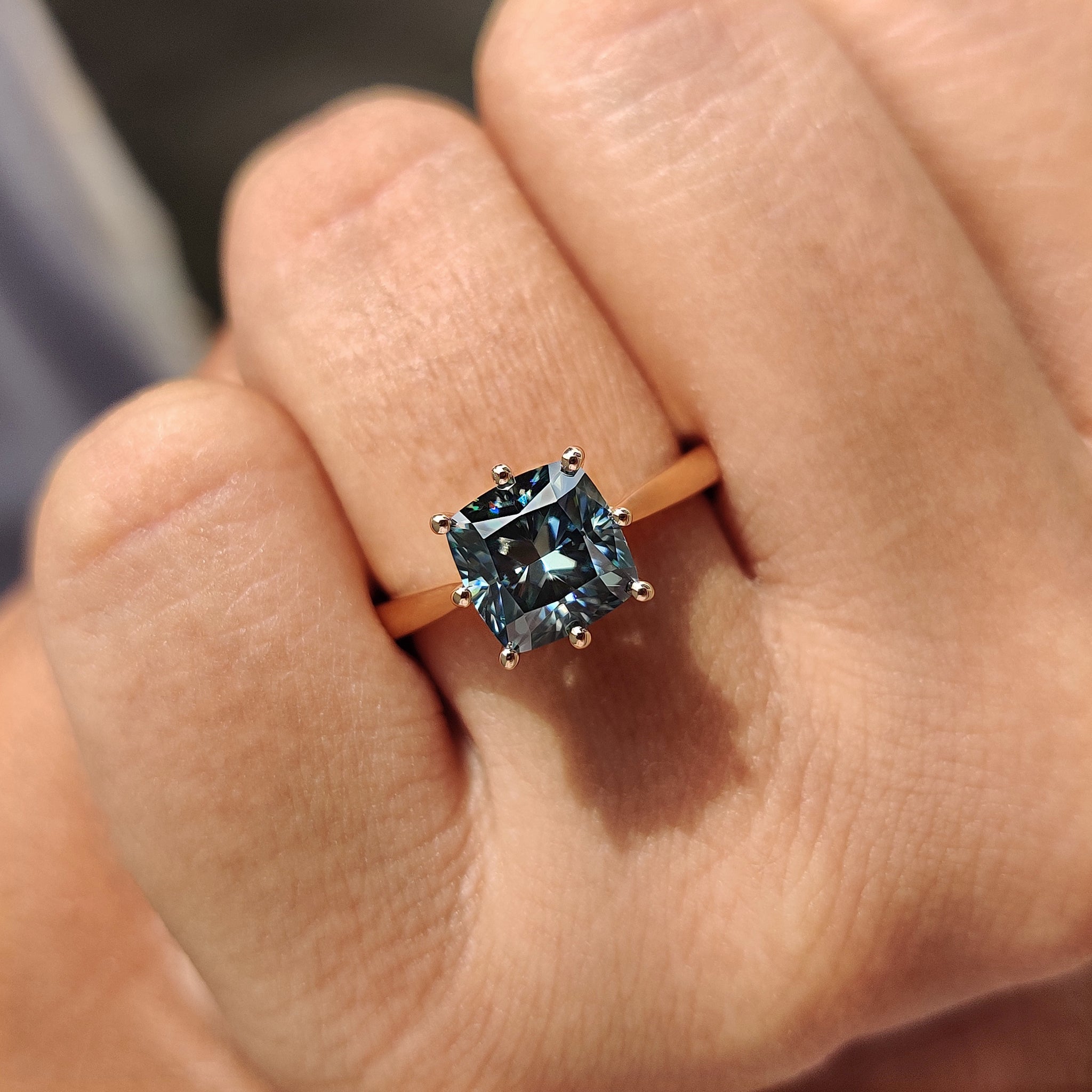 Cushion cut hidden halo engagement ring beams with mystery.