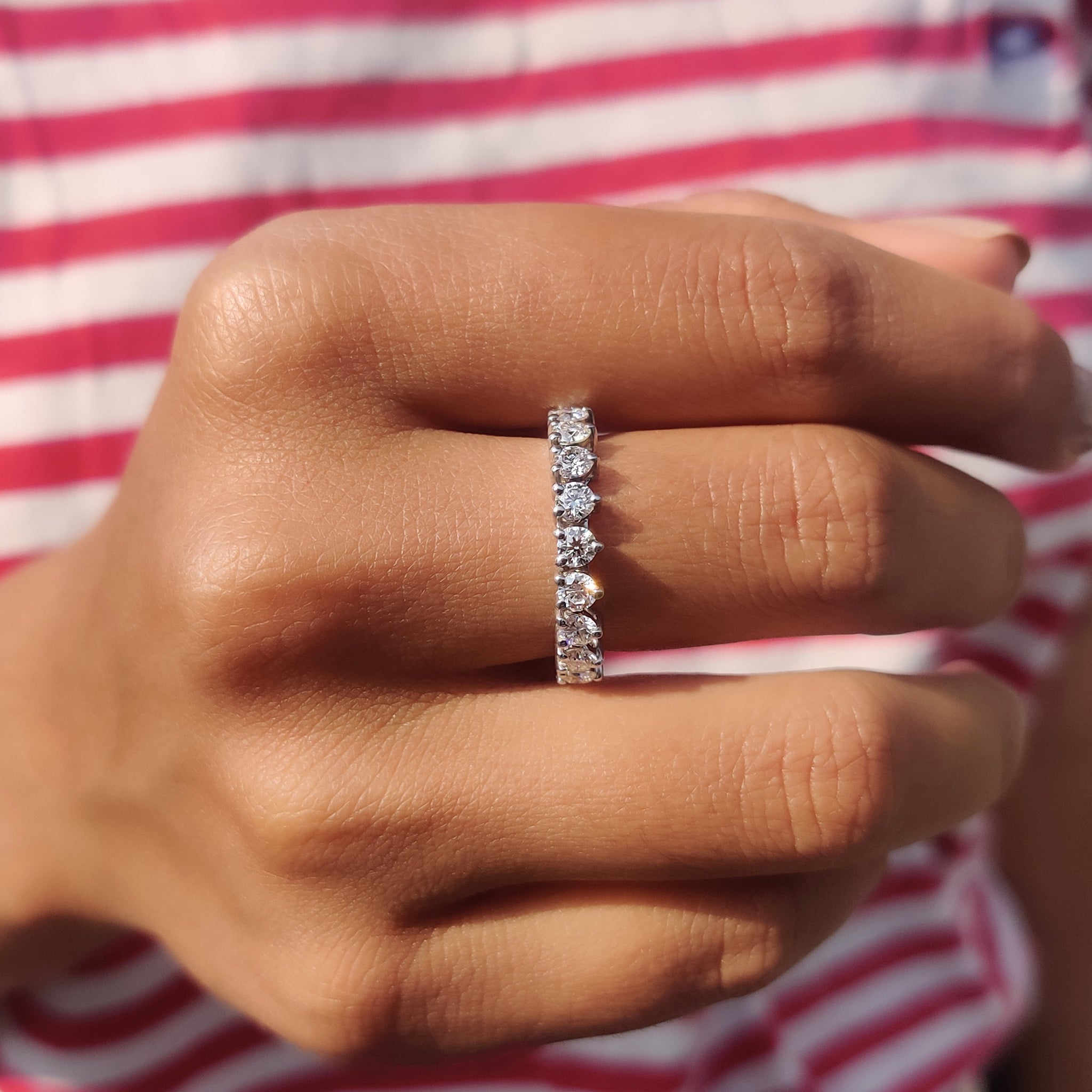 White gold wedding band crafted with moissanite stones for a sleek and polished look.