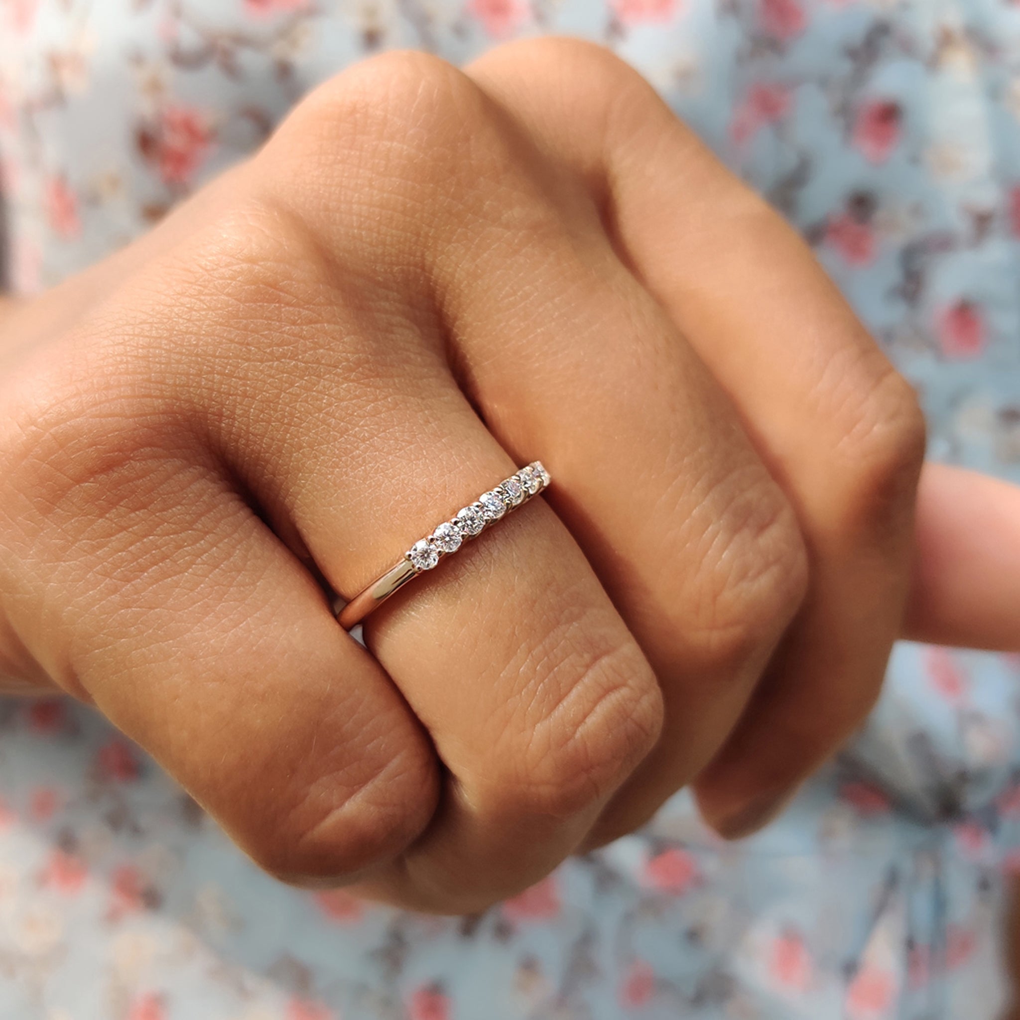 Semi eternity band with hand-set round moissanite stones, ideal for a unique wedding ring.