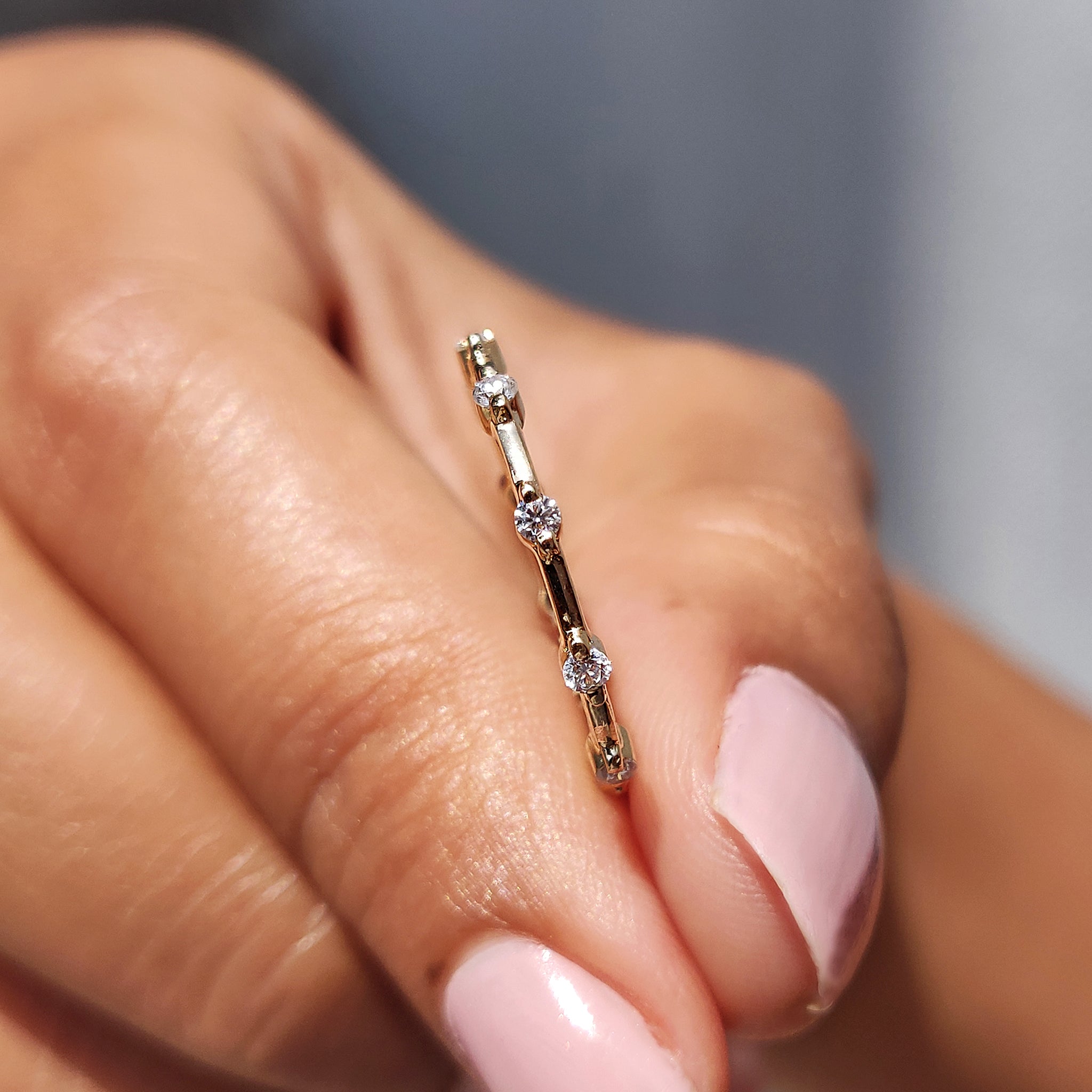 Distance pave set wedding band with sparkling accents.