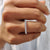 Shared prong wedding band with moissanite stones, crafted for continuous brilliance and secure setting.