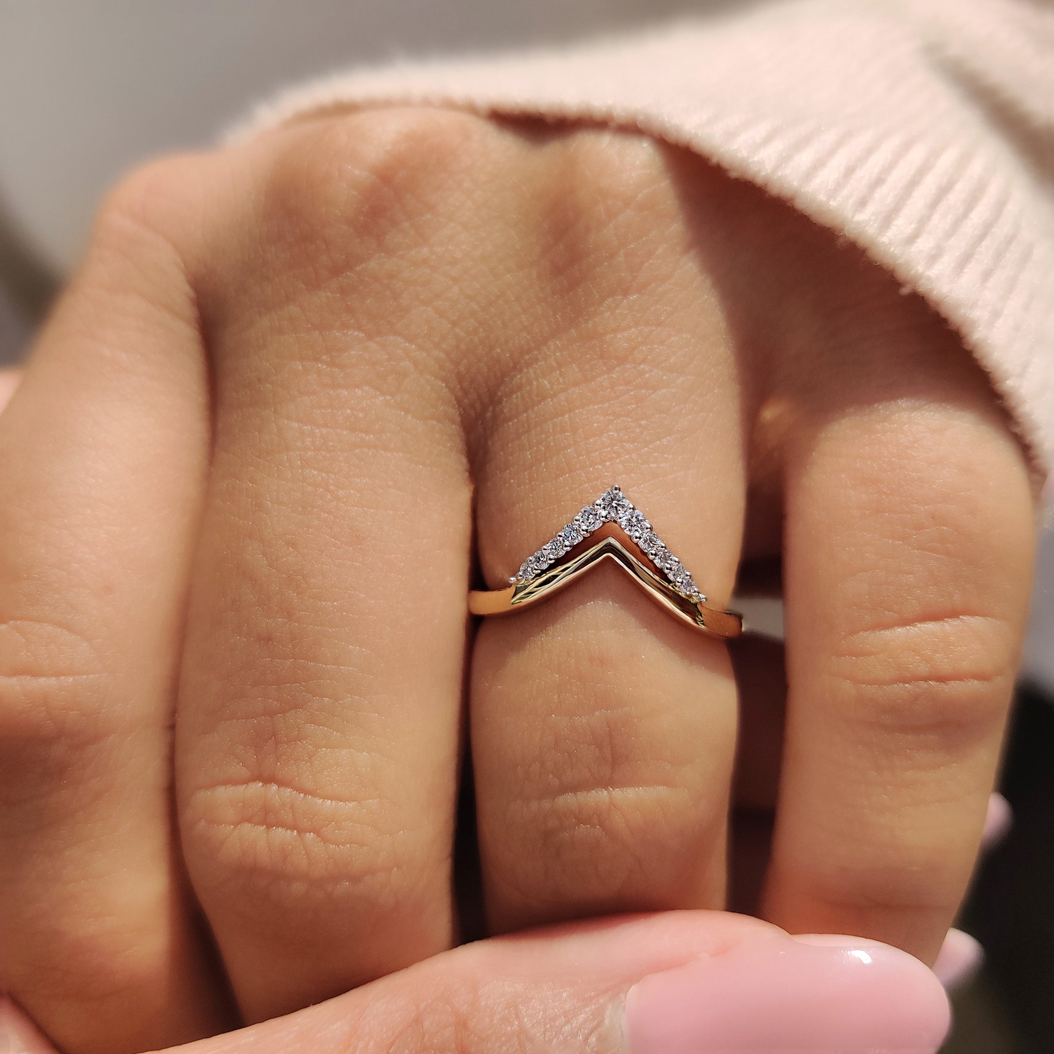 Round cut moissanite band set in a classic gold setting.
