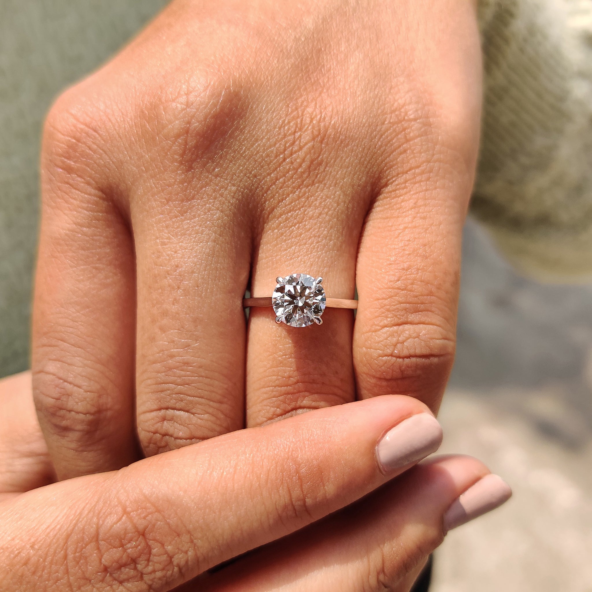 Buy engagement ring featuring a round solitaire diamond.
