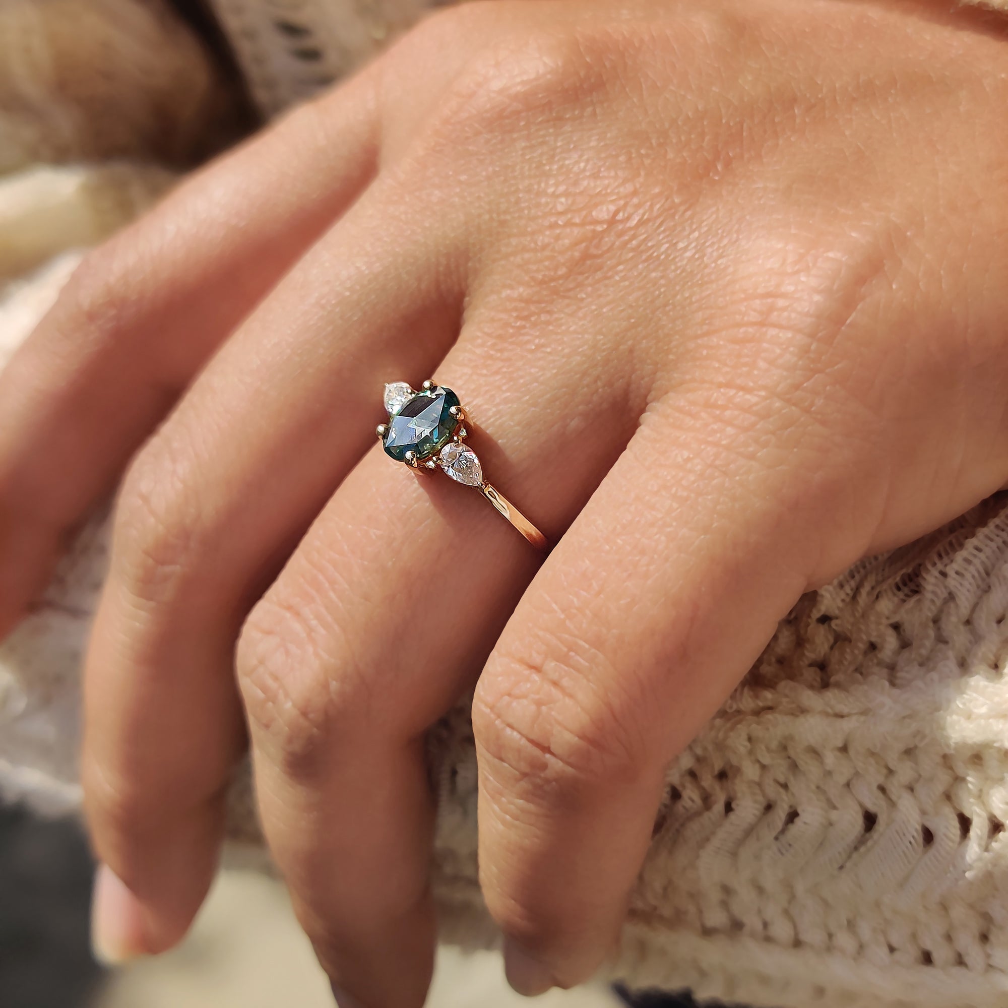 Moissanite three stone ring with pear side stones