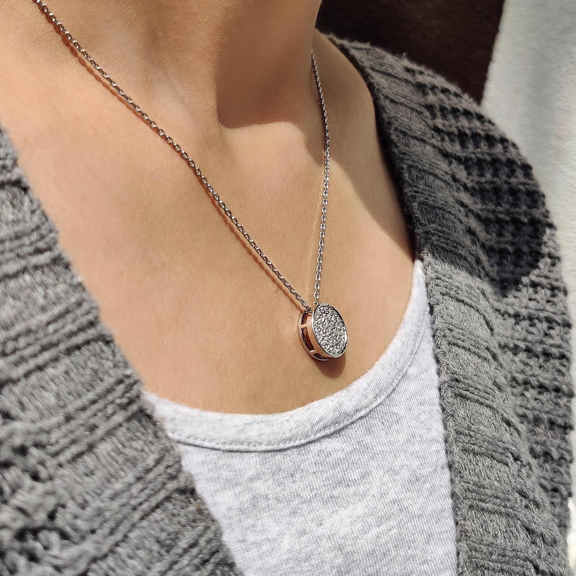 Unique diamond pendant with round diamonds in a cluster arrangement.
