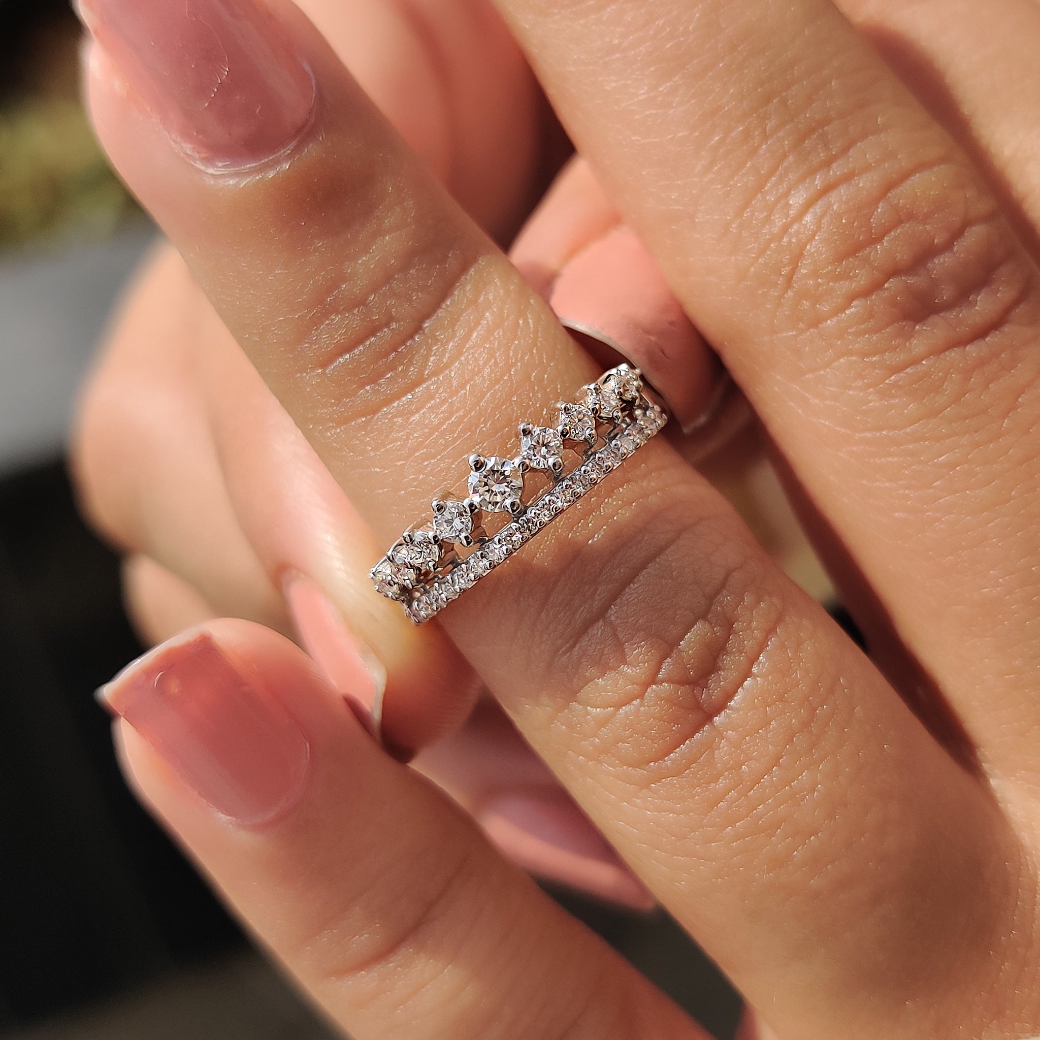 Carat diamonds wedding band on a silk fabric background.
