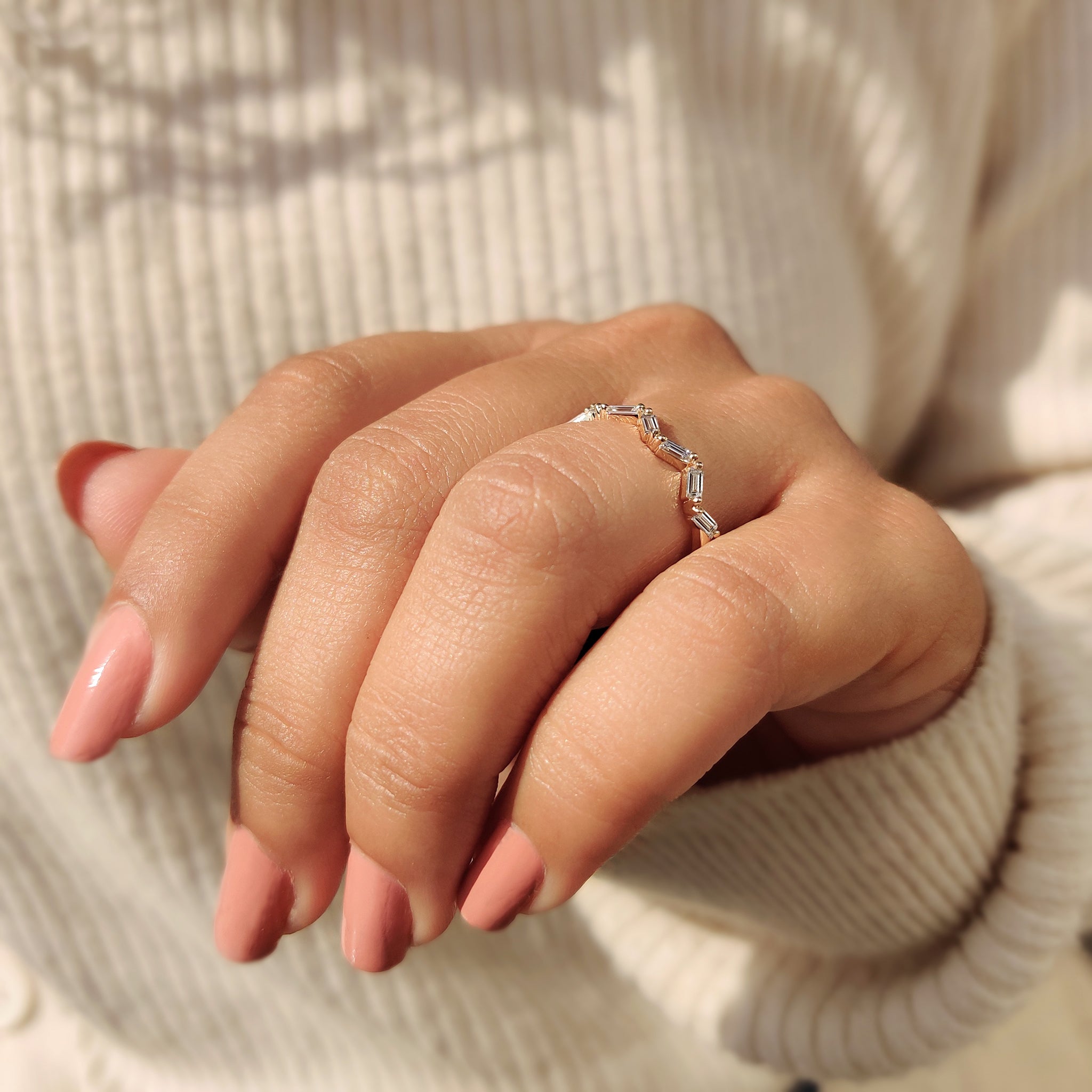 Moissanite yellow gold band featuring shimmering moissanite stones.
