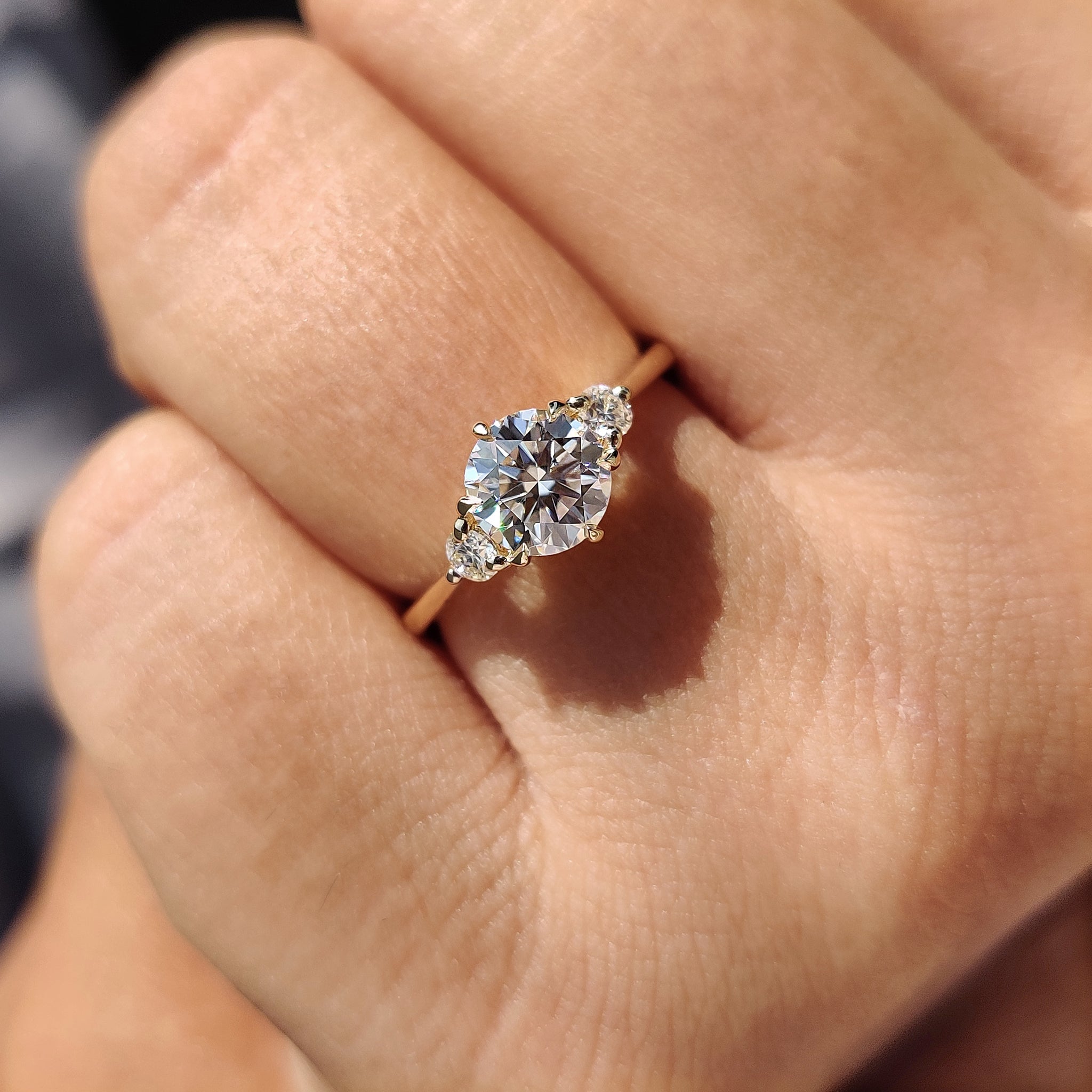 Custom engagement ring with round cut Moissanite set in a yellow gold band.
