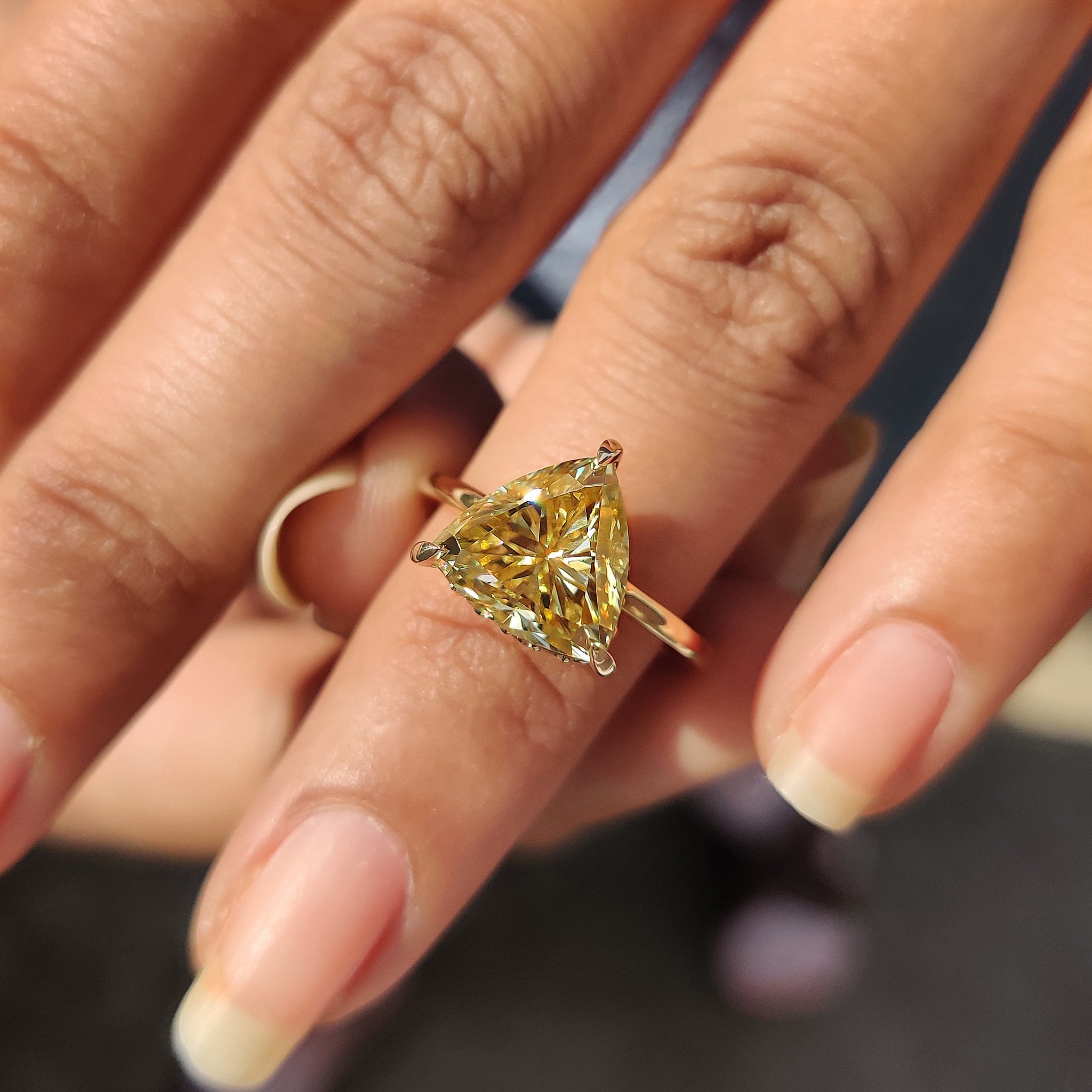 Custom engagement ring featuring a trillion cut stone in a classic 3 claw prong setting.