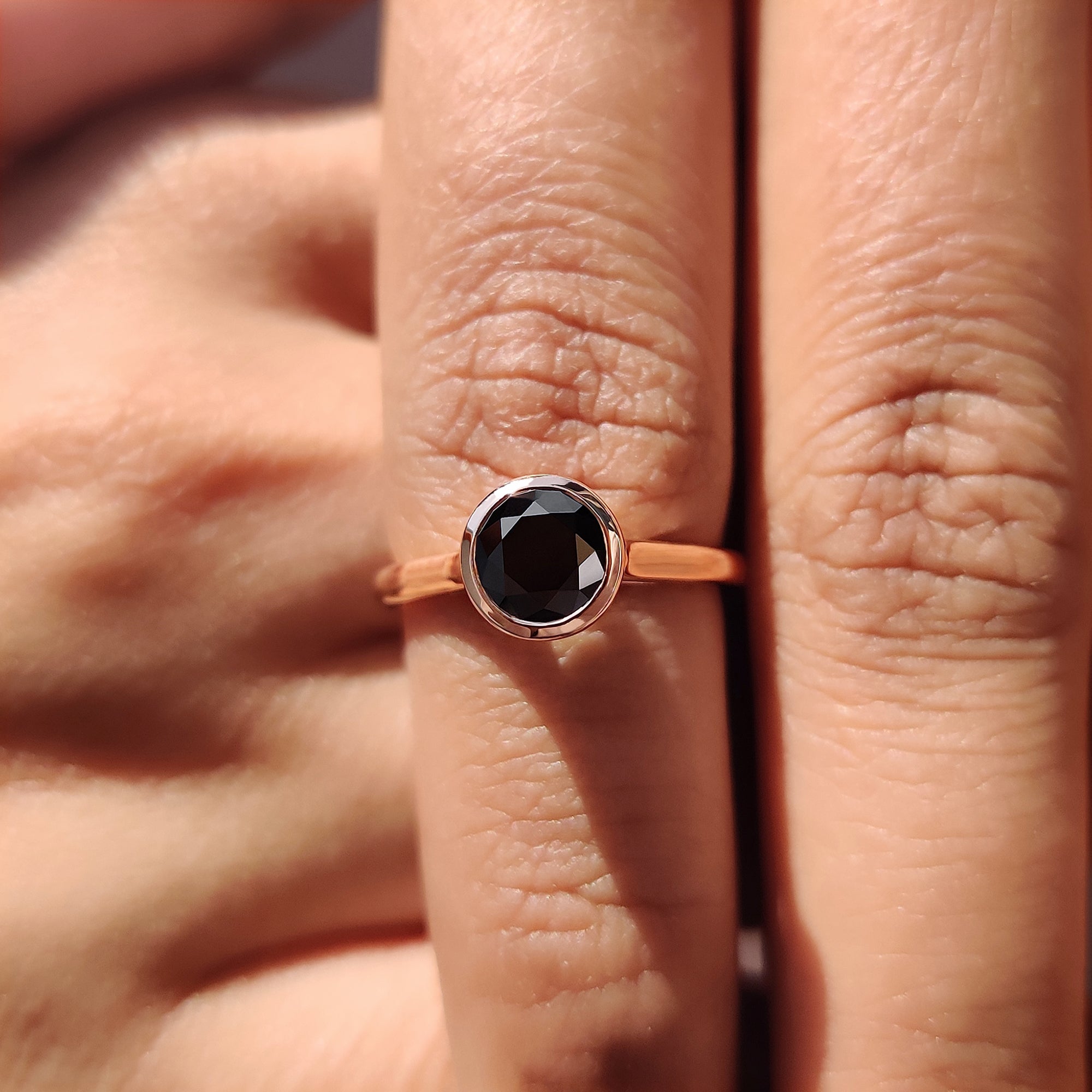 Handmade jewelry ring featuring a bezel setting and black Moissanite centre.
