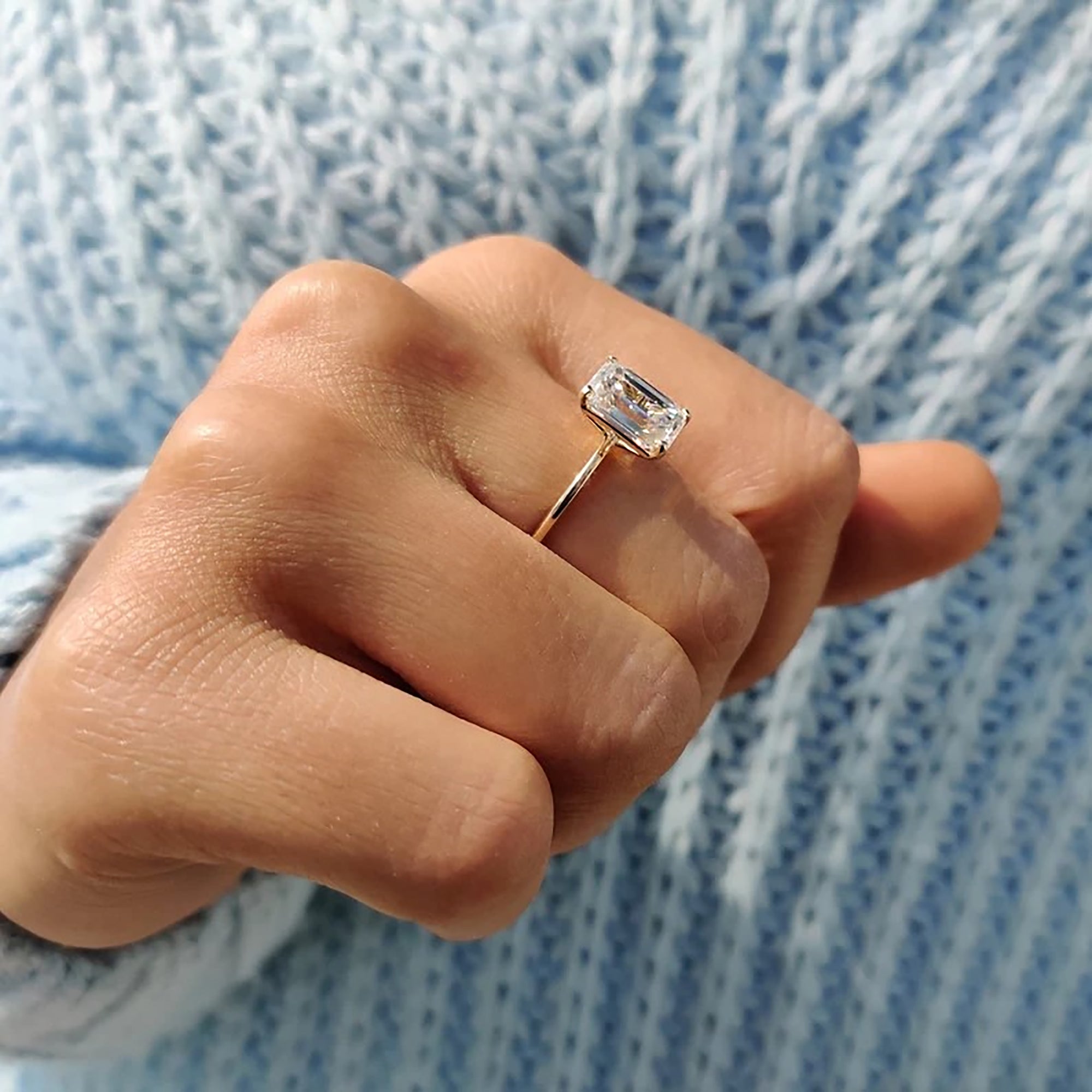 Emerald cut ring set in polished yellow gold.
