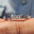 Baguette cut eternity band featuring blue moissanite stones in a full circle design.
