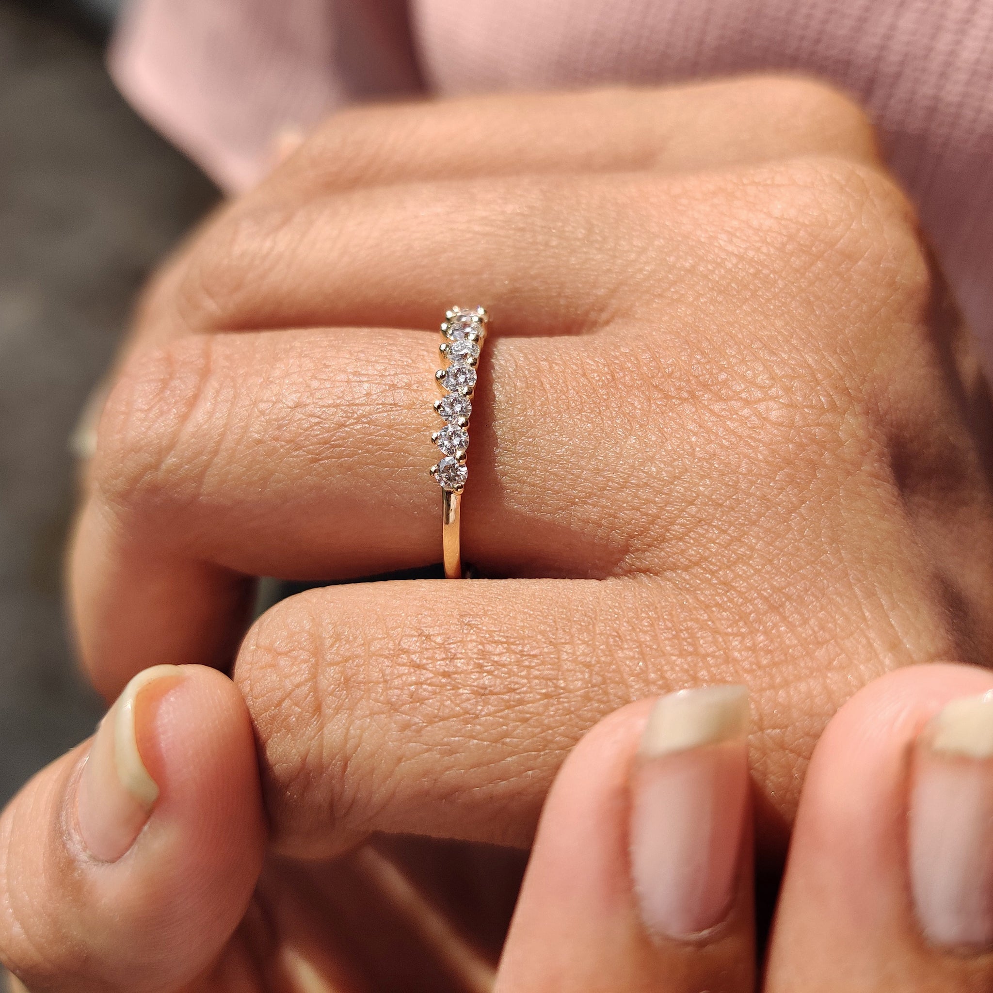 Carat Diamonds band featuring brilliant round cuts.
