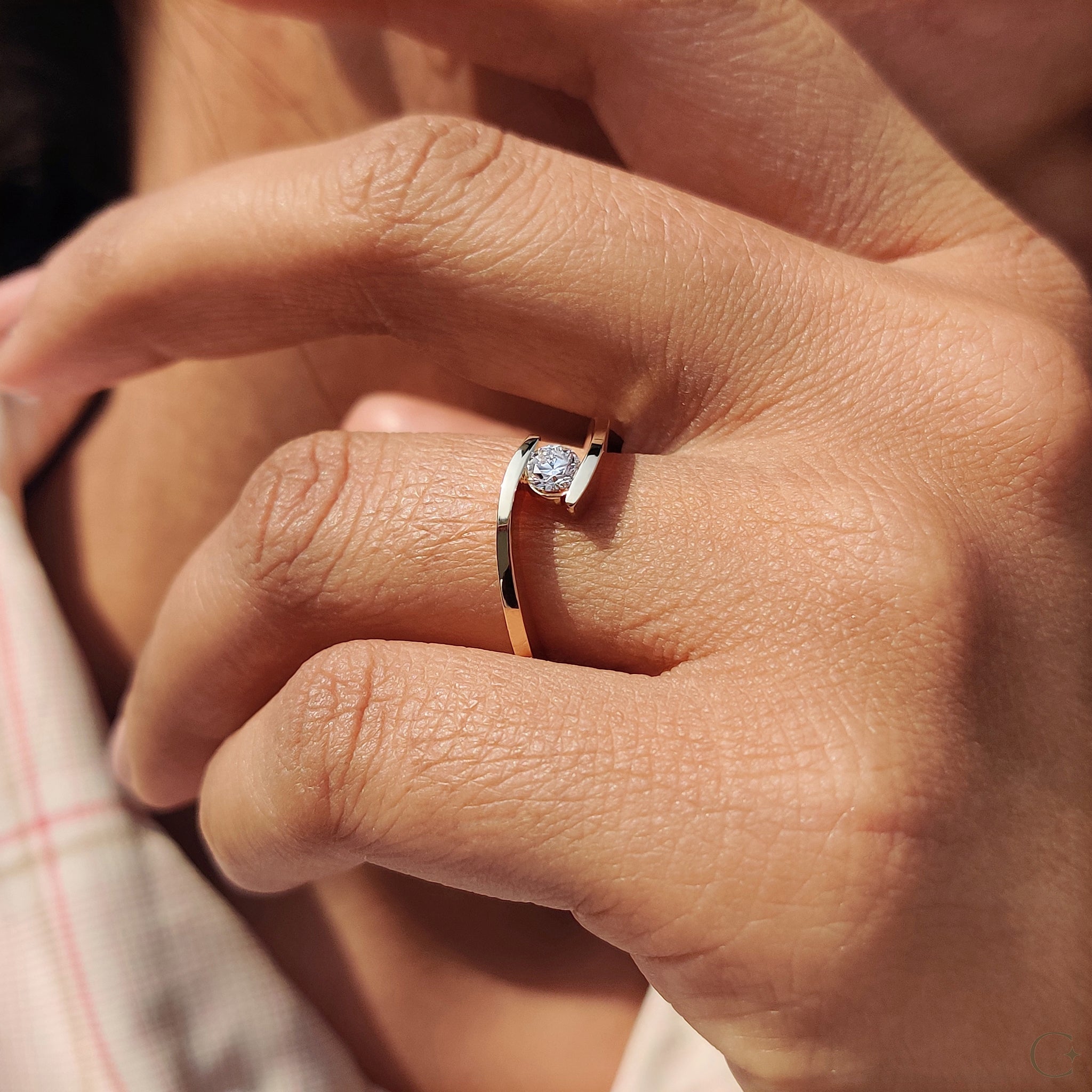 Solitaire setting ring featuring a single diamond.
