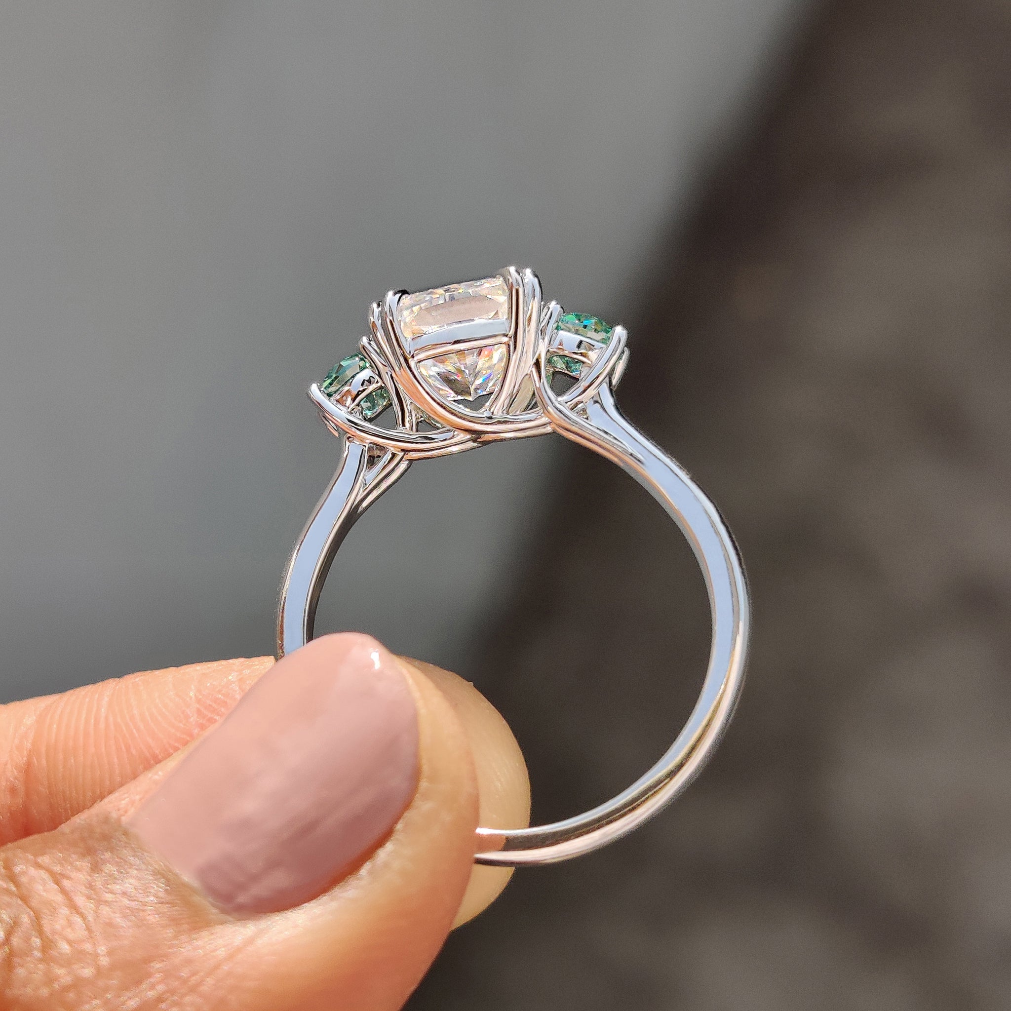Moissanite ring with old European cut green side stones.