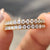 Close-up of a Moissanite Half Eternity Band featuring sparkling round stones set in yellow gold.
