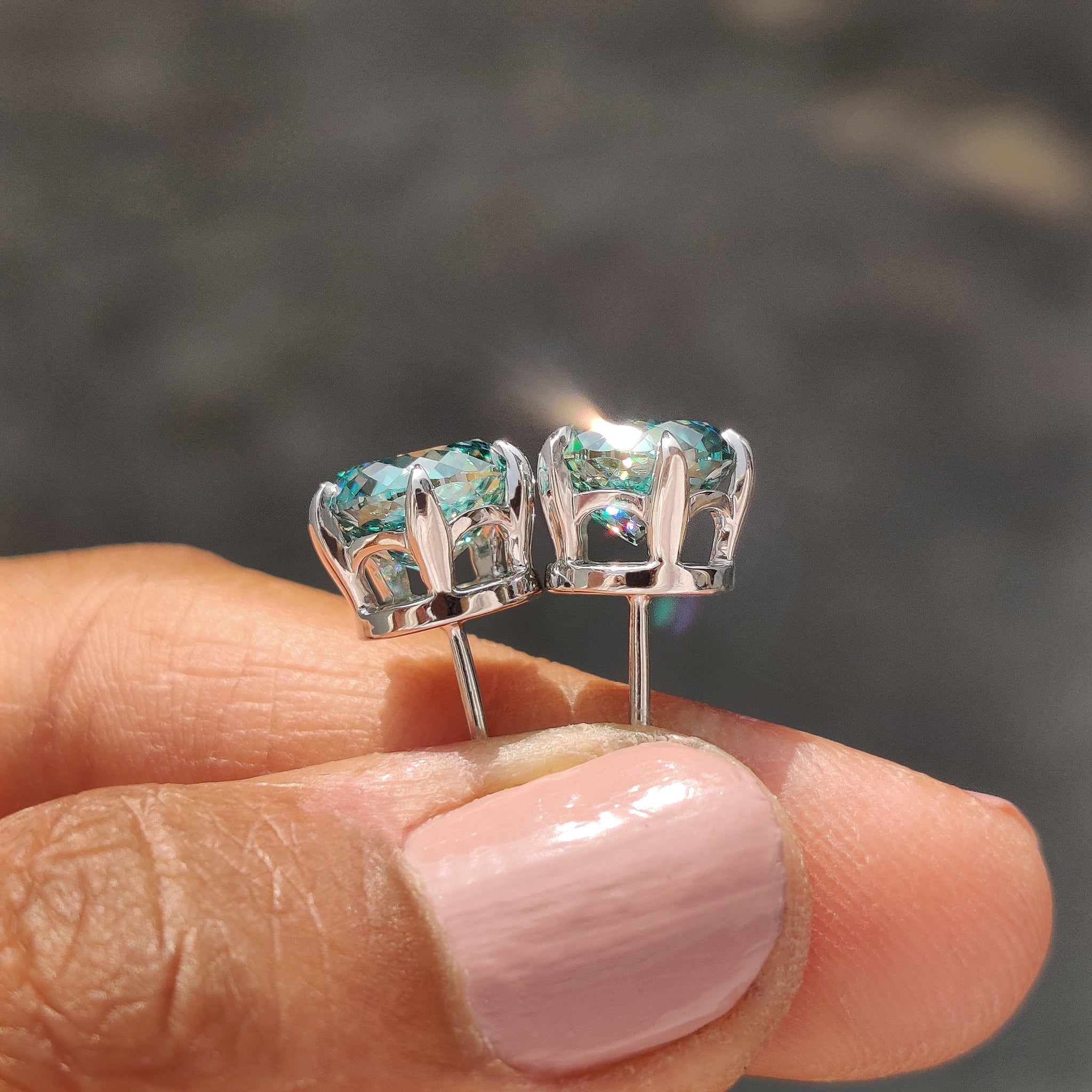 White gold stud earrings featuring Portuguese Cut Cyan Blue Moissanite Earrings with push back earrings.
