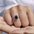 Black oval engagement ring shows bold modern design.