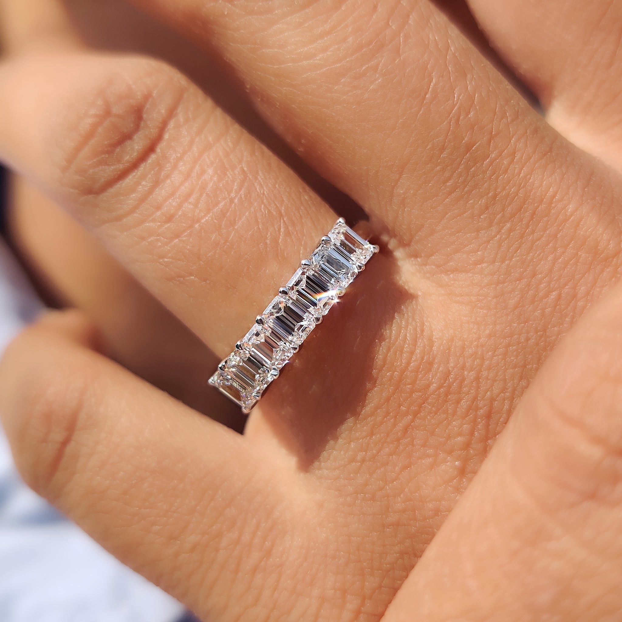 Custom white gold wedding band featuring 7 prong set diamonds.
