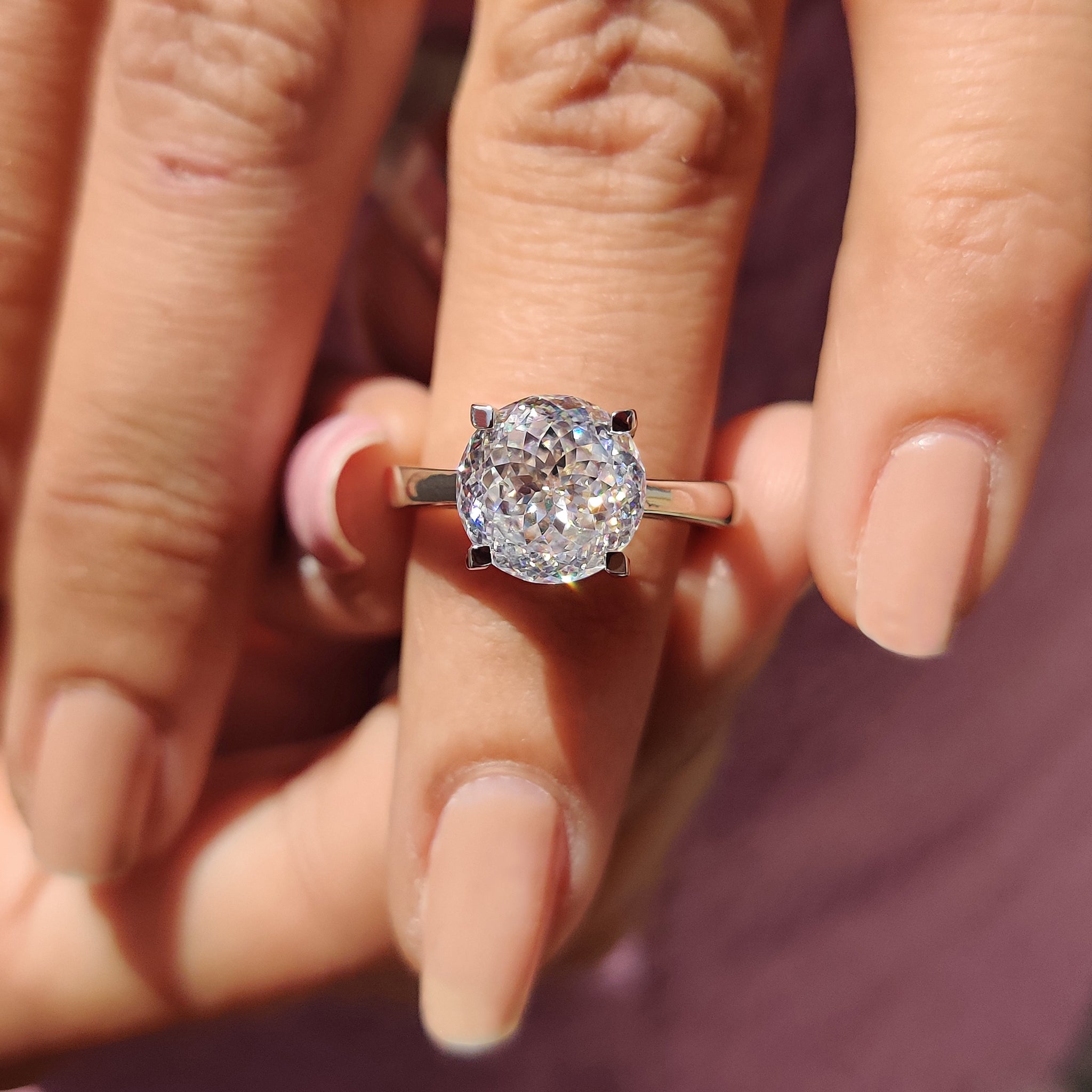 Simple engagement ring holds soft strong heartfelt charm.