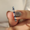 Blue diamond eternity band set in a sleek design for a modern wedding look.
