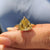 Solitaire setting with a canary yellow trillion cut moissanite engagement ring.