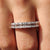 Emerald cut wedding band with clean lines and step-cut moissanite stones for a modern bridal look.