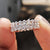 Elegant full eternity band featuring round moissanite stones in a white gold band.