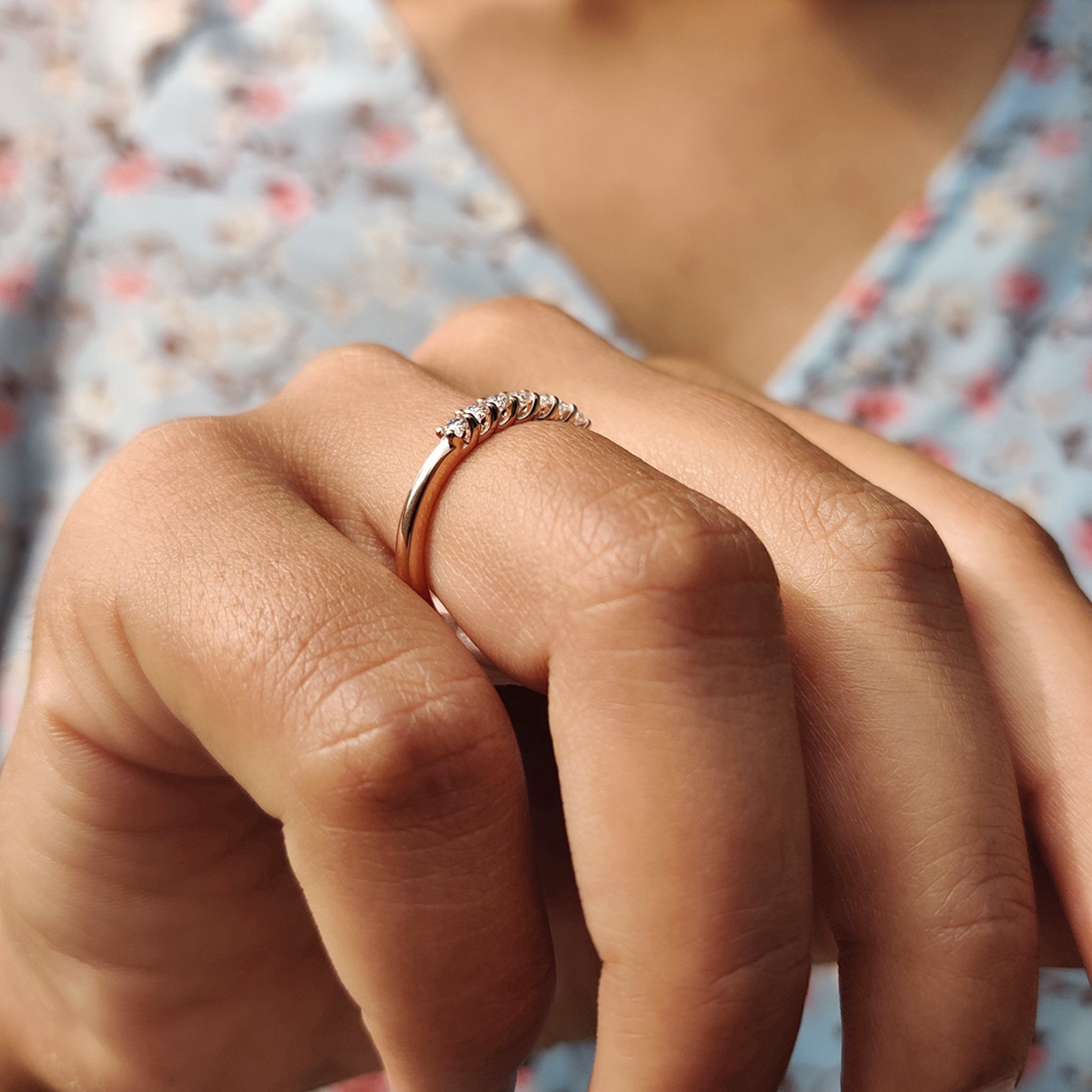 Moissanite wedding band designed with round stones, available in a custom-made style.