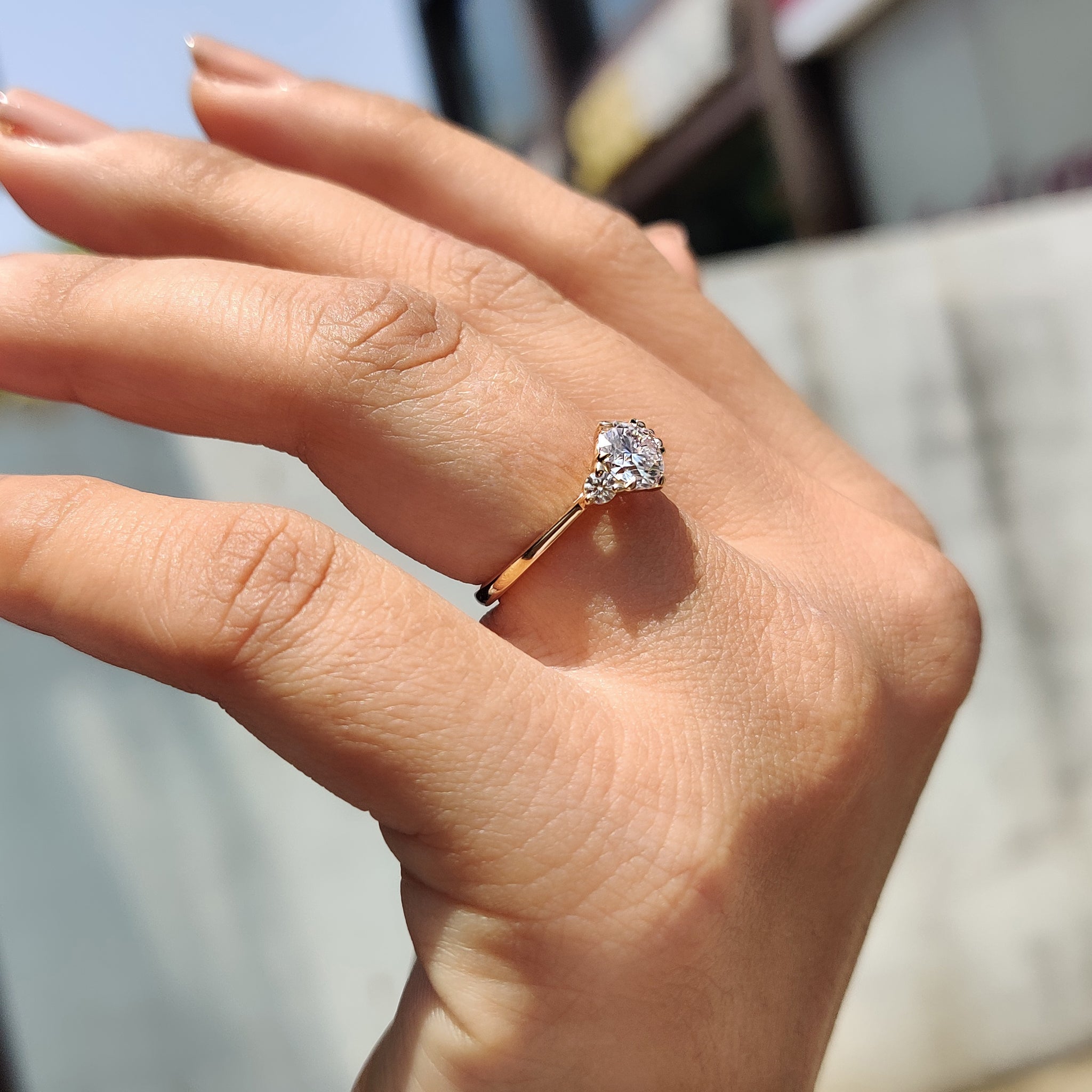 Handmade ring featuring a three stone design and round cut Moissanite for added brilliance.