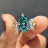 Pear cyan blue engagement ring with a stunning Moissanite centre stone in a white gold band.
