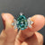 Pear cyan blue engagement ring with a stunning Moissanite centre stone in a white gold band.
