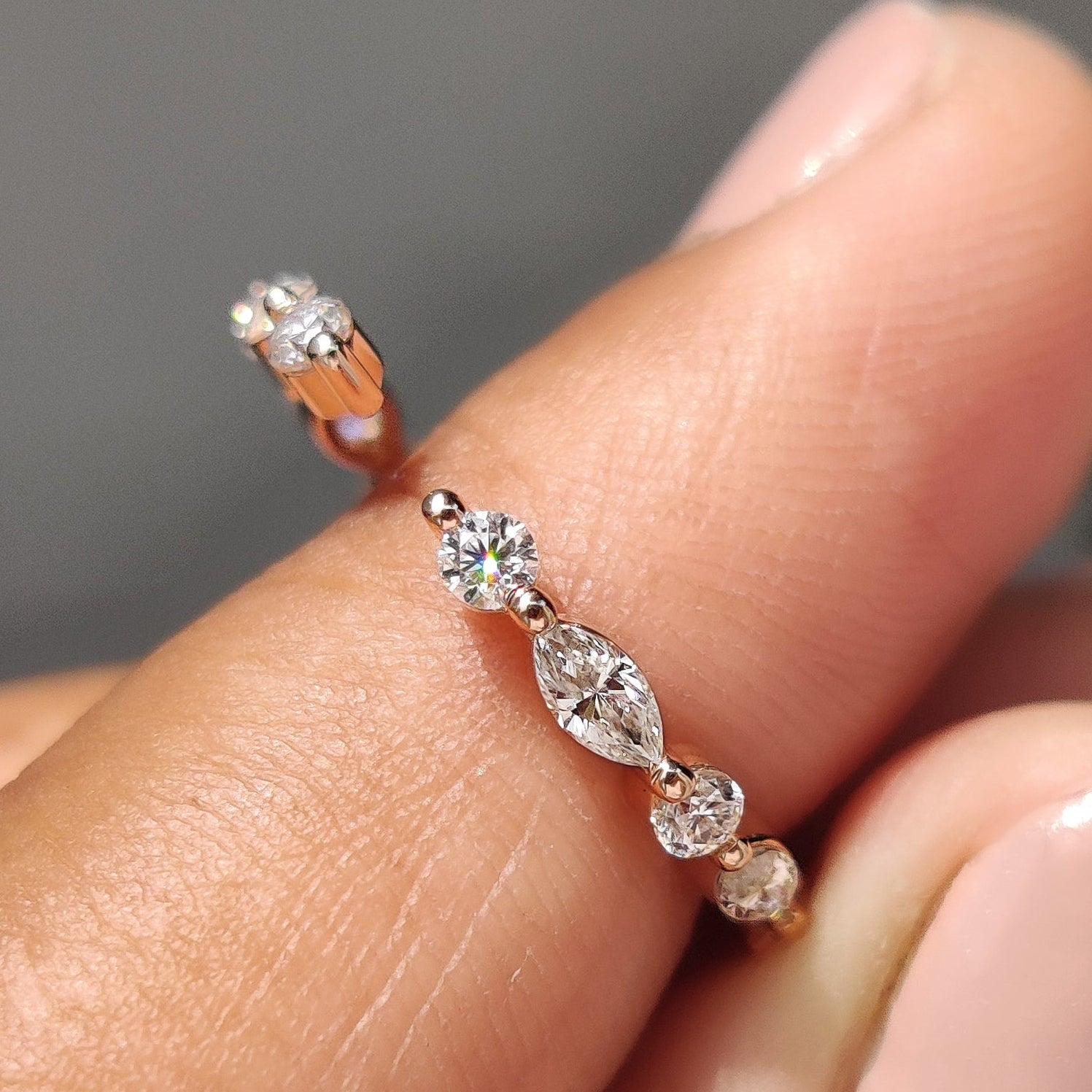 Marquise and round wedding band featuring a round cut band design.