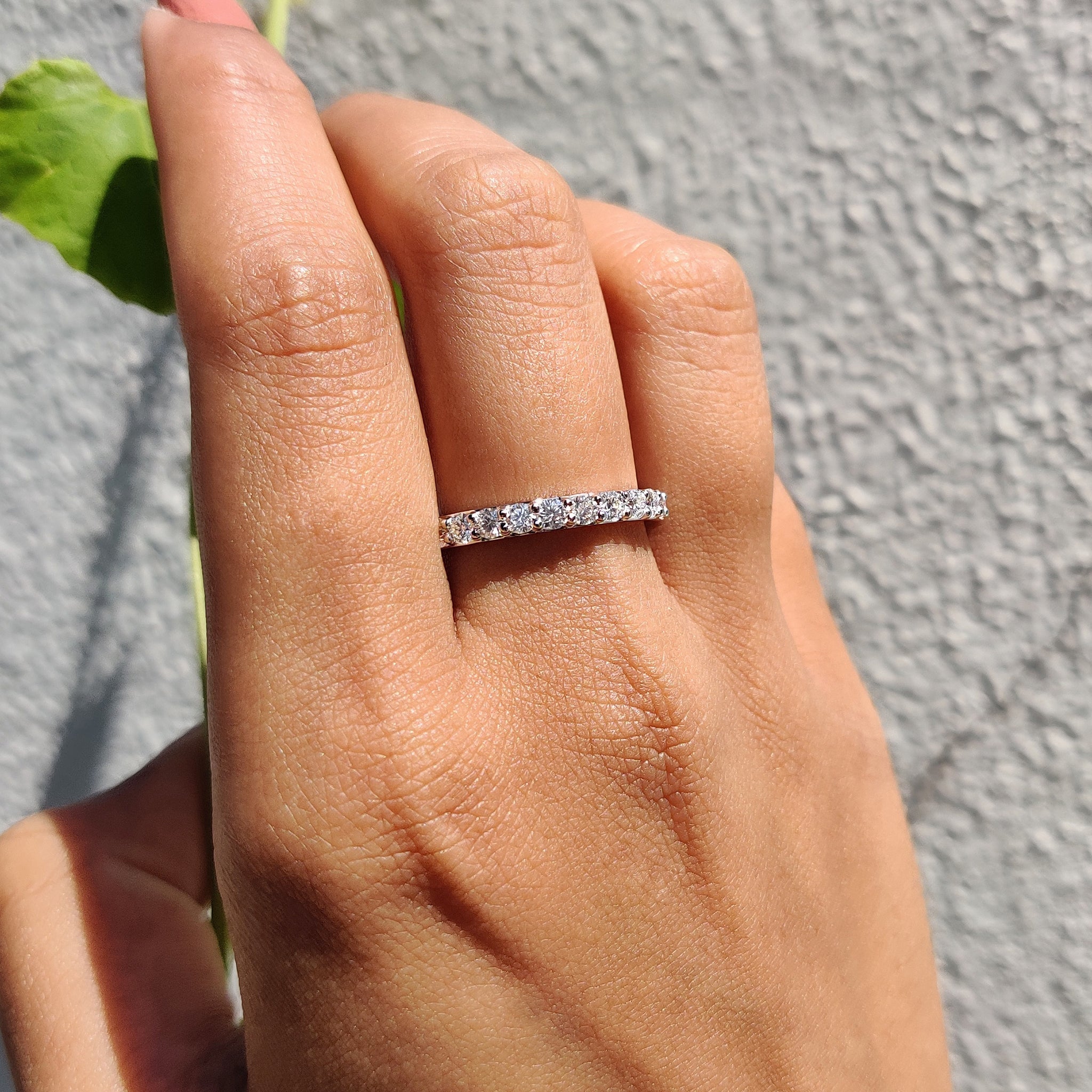 Prong set wedding band with white gold moissanite band.