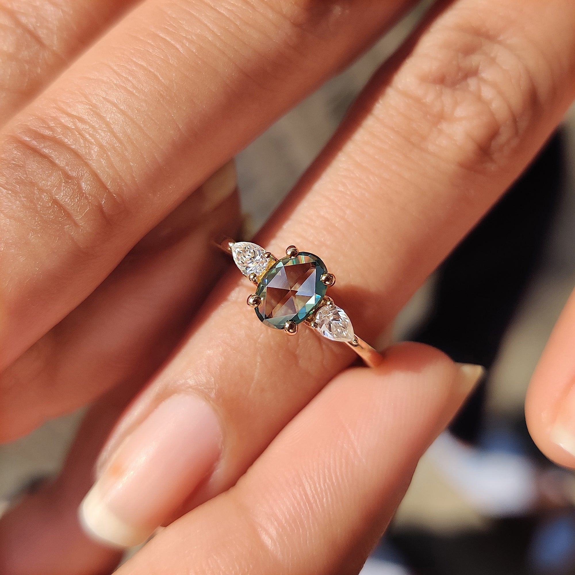 Custom yellow gold ring with oval and pear Moissanite cuts