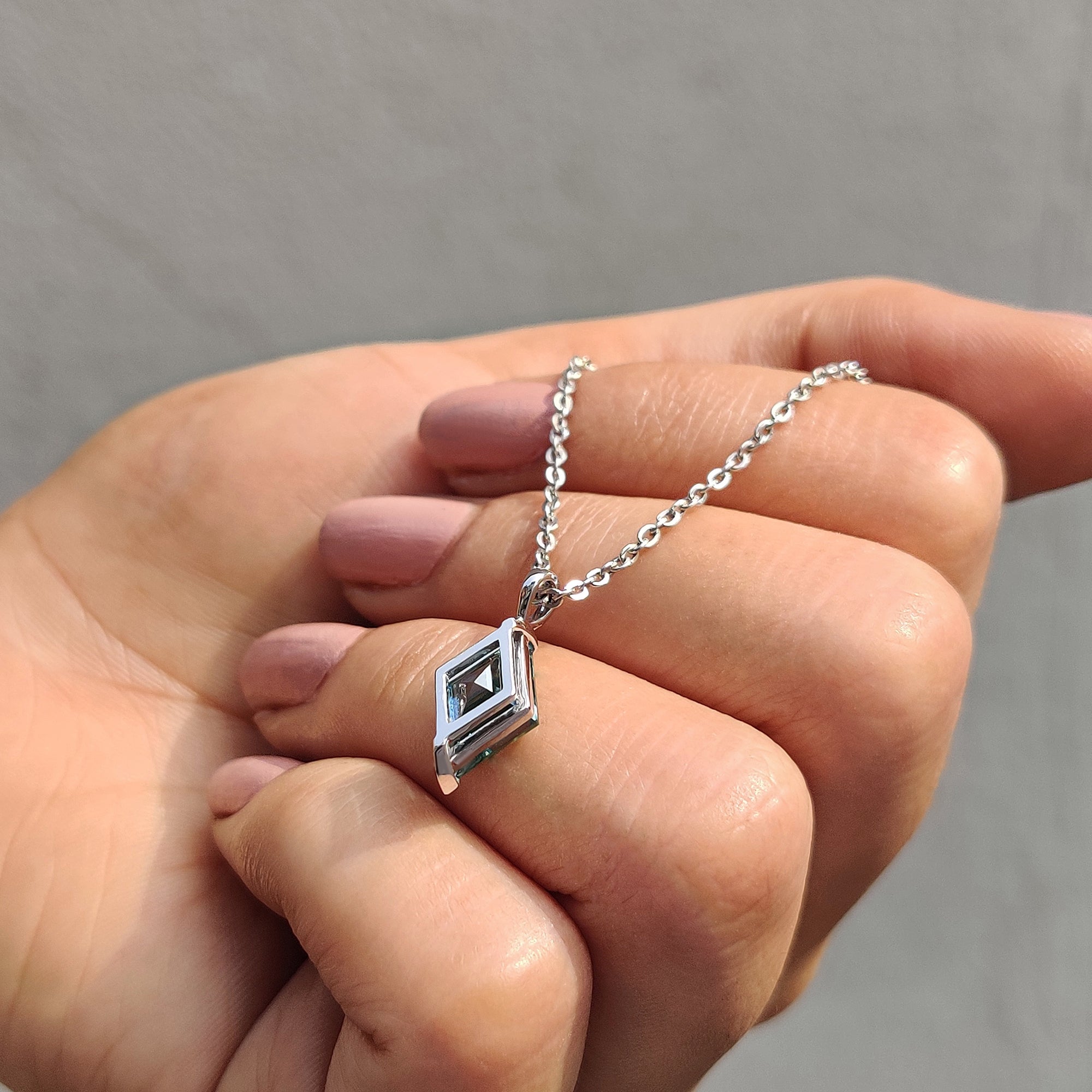 Lozenge cut moissanite pendant styled as a moissanite pendant for women.
