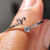 Round cut band featuring Aries sign detail and moissanite stones.