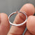 Round cut wedding band with 3 prong setting.