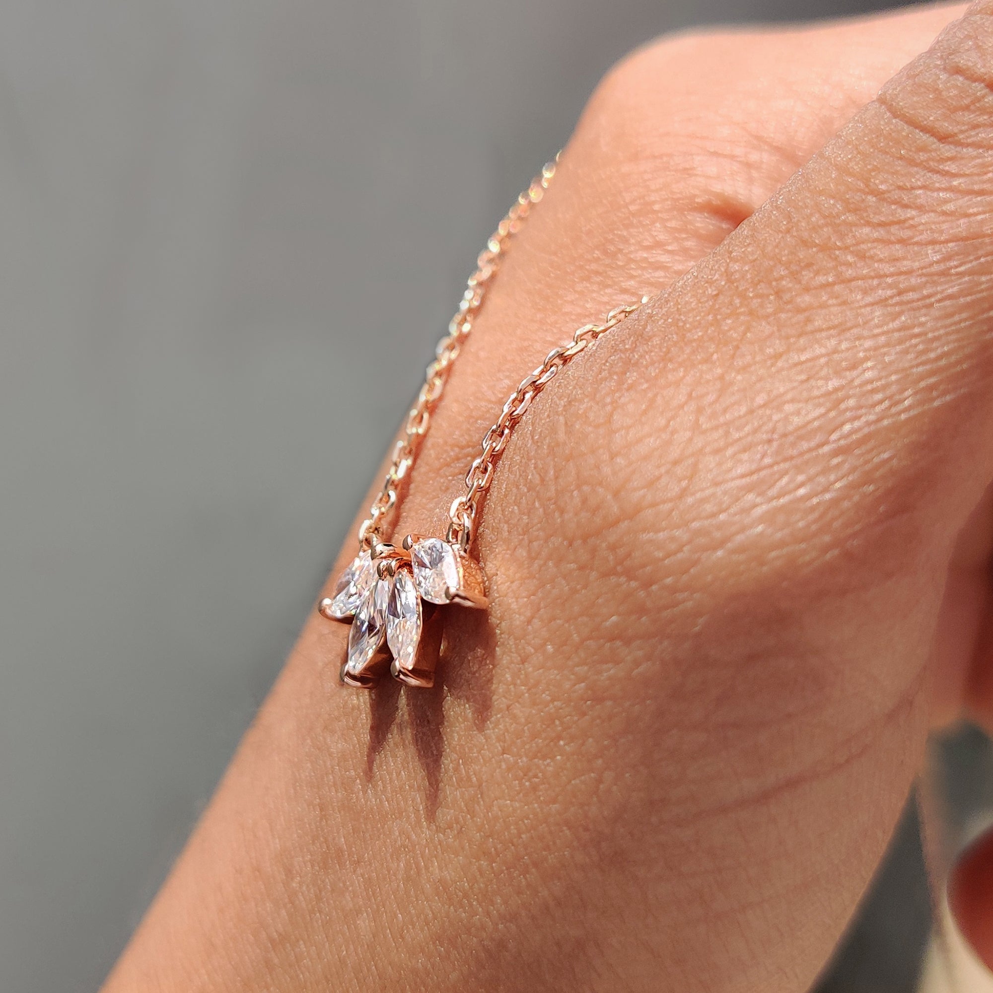 Arc Marquise cut Pendant made with prong set pendant and moissanite pendant detail.
