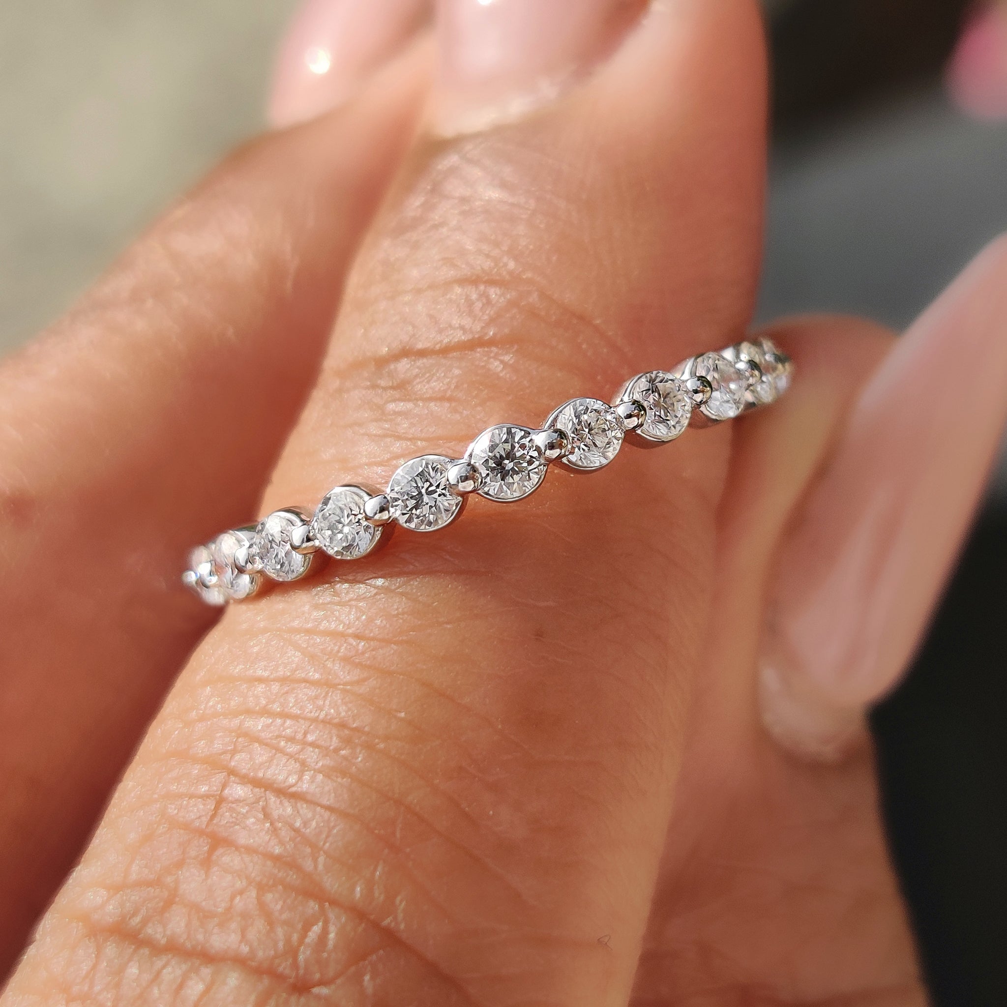 Round diamond wedding band with sparkling diamonds.
