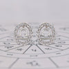 Libra earrings in white gold with round diamond halo studs.

