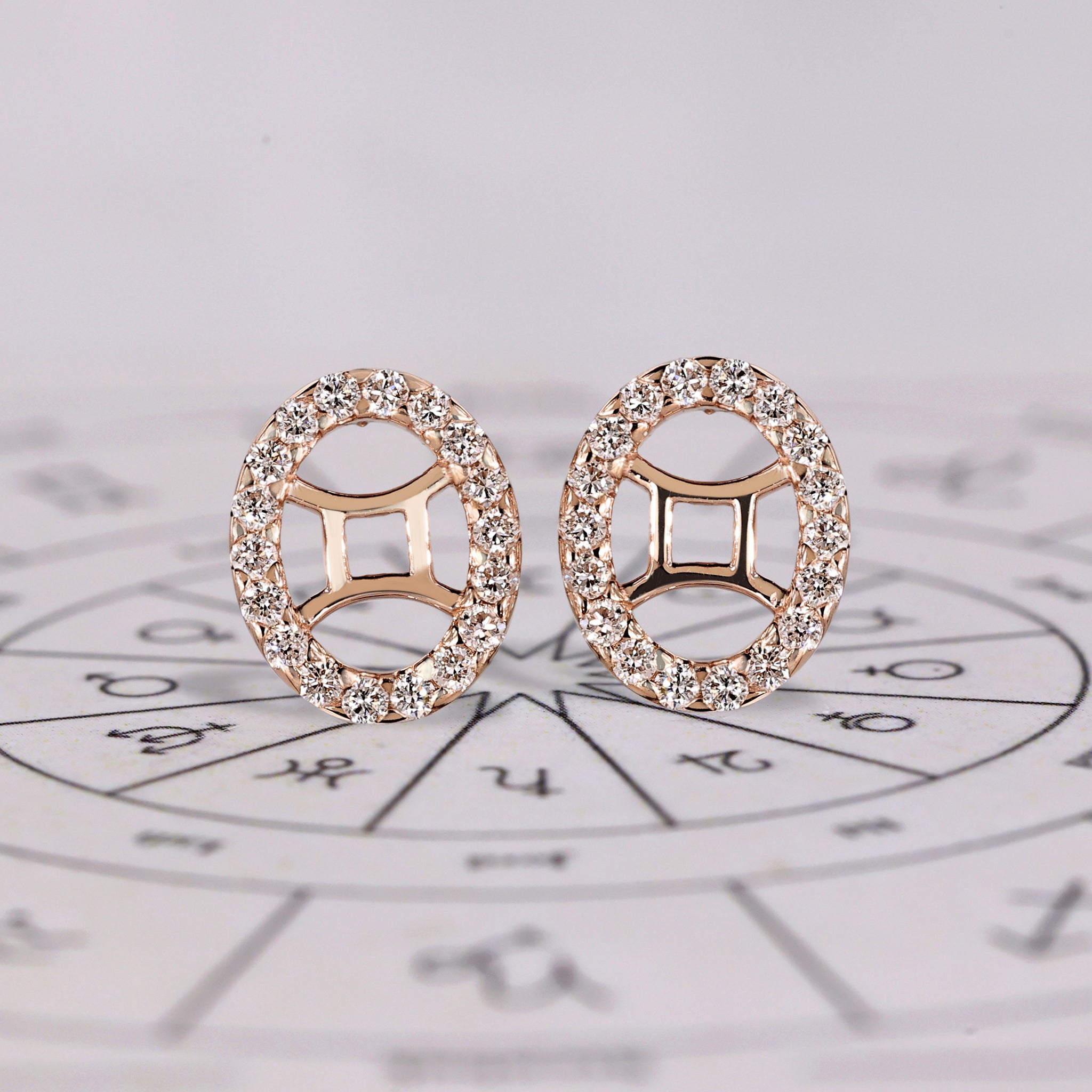 Gemini earrings in rose gold with round cut halo studs.

