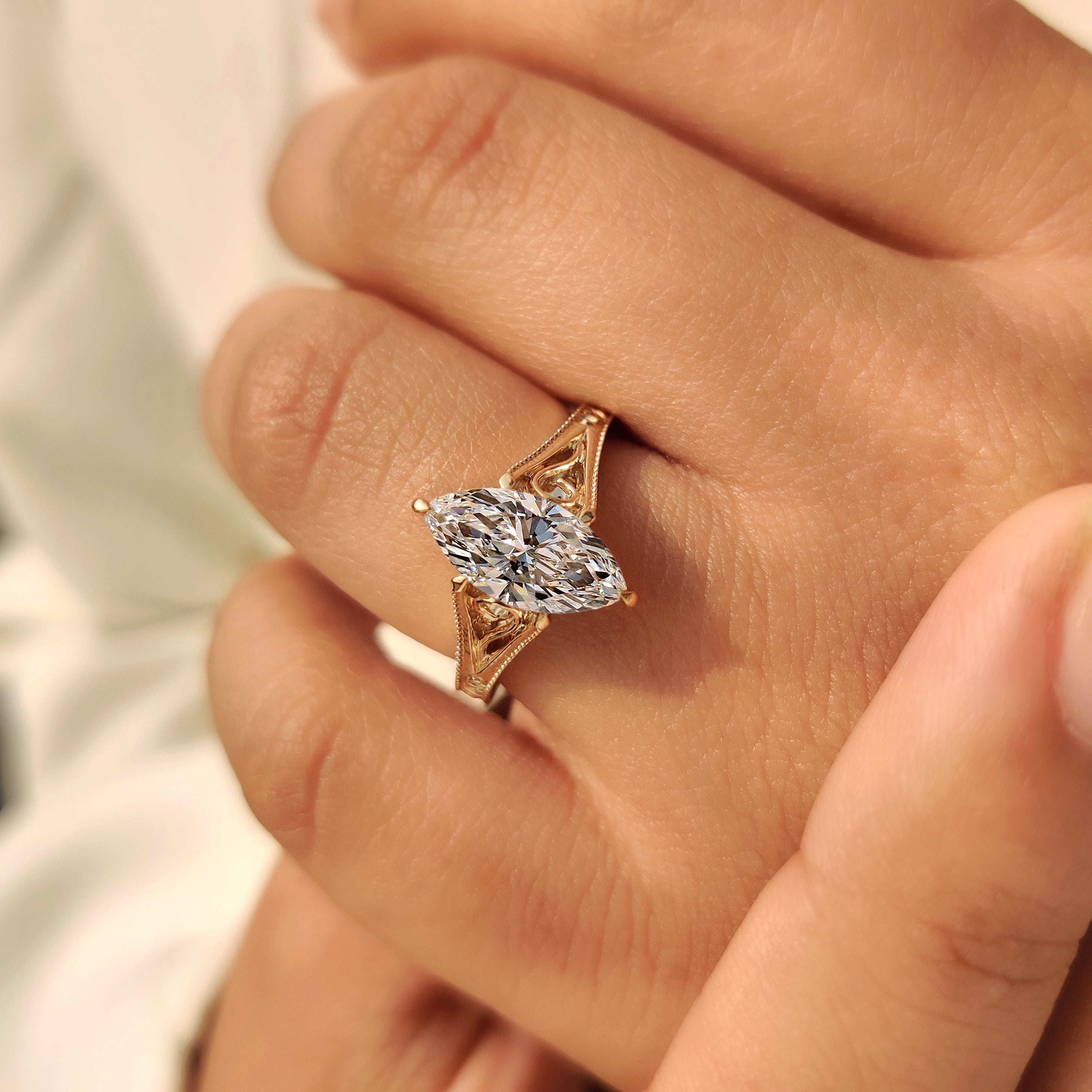 Handmade marquise cut diamond ring with milgrain border details.
