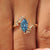 Blue Dutch marquise center diamond in a six claw prong setting.

