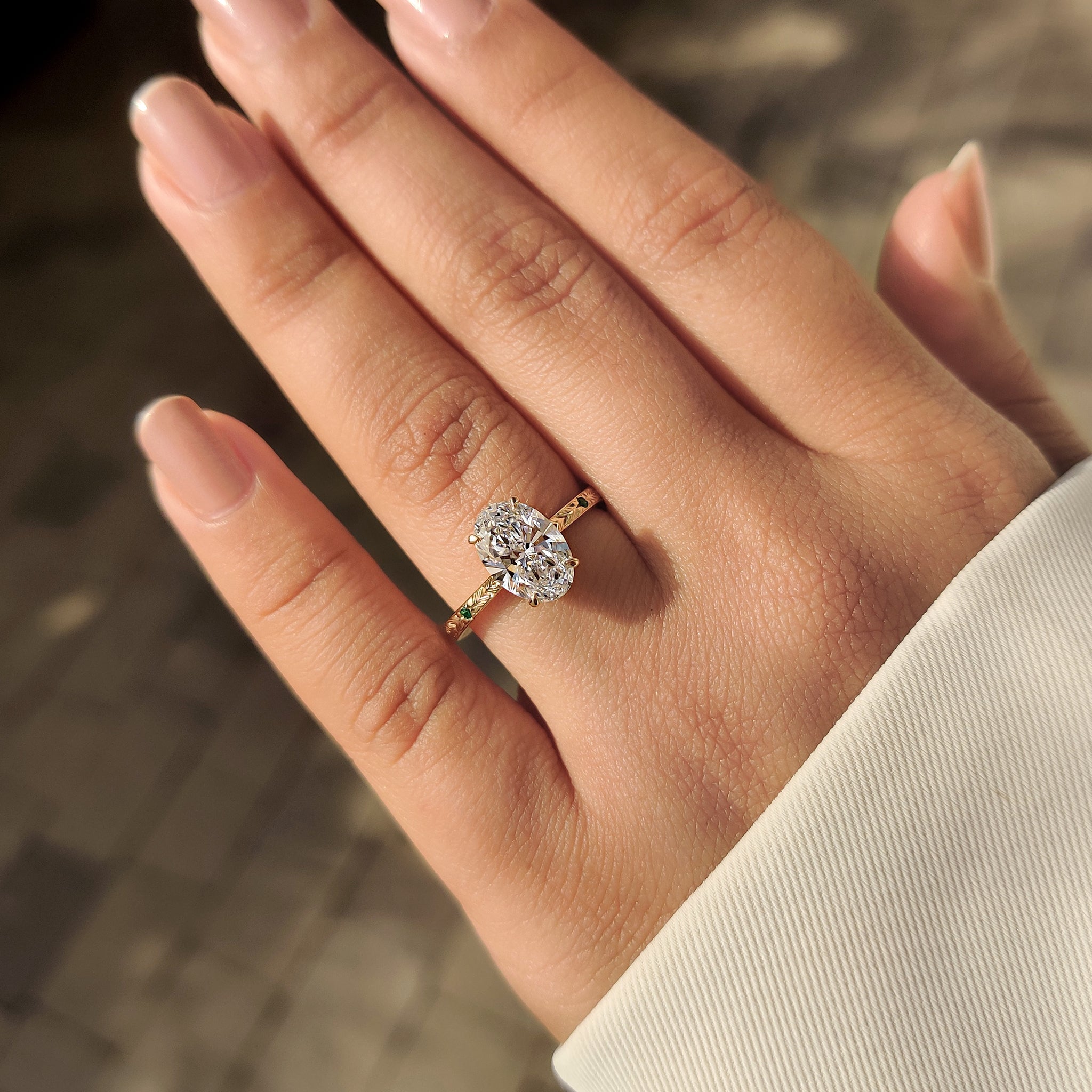 Oval lab grown diamond ring with four claw prong setting.
