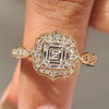 Asscher cut diamond ring with round cut halo setting.
