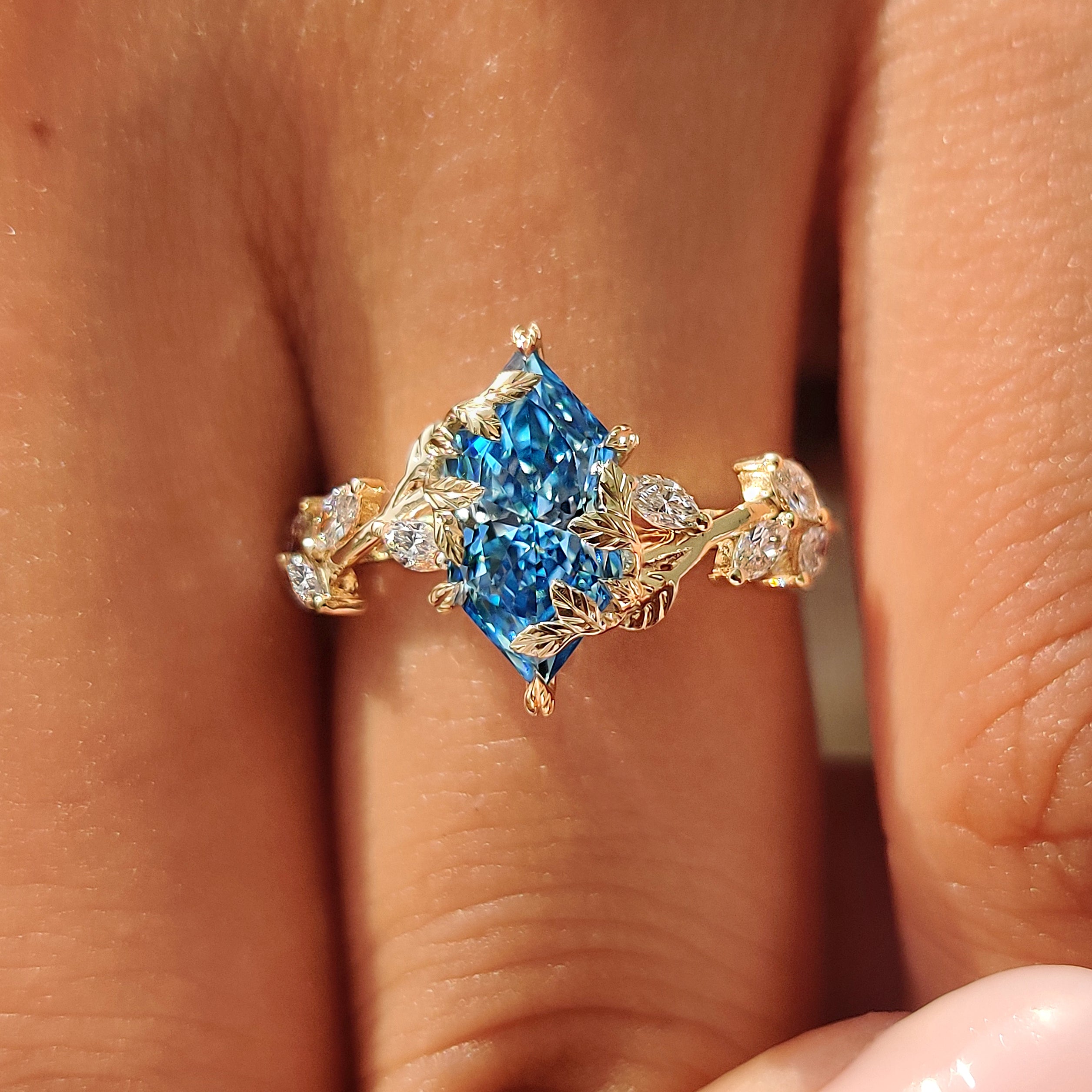 Leaf and vine details surrounding the blue center diamond.
