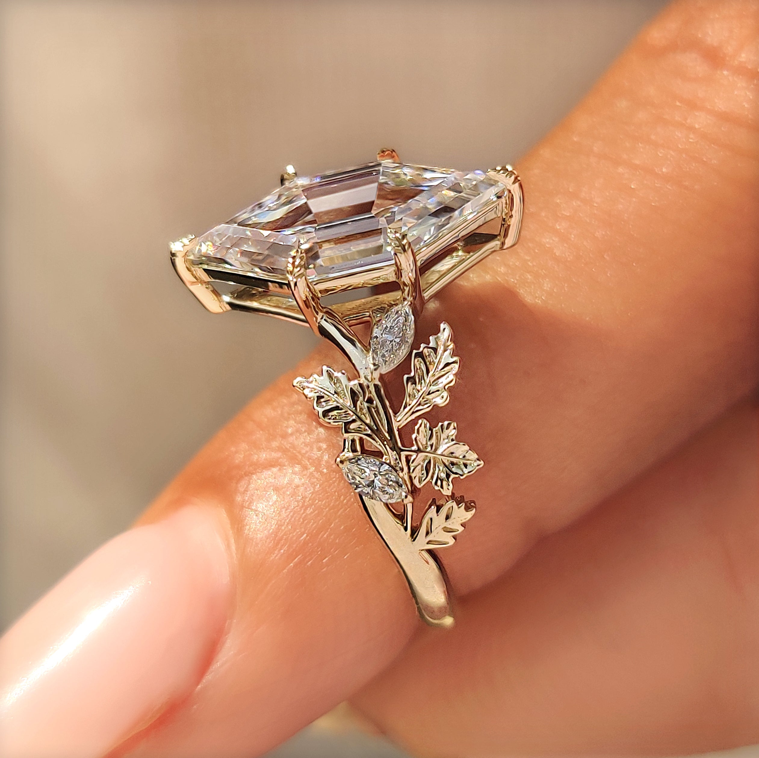 Oak and Maple Leaf detailing along the shoulders of a hexagon diamond ring.
